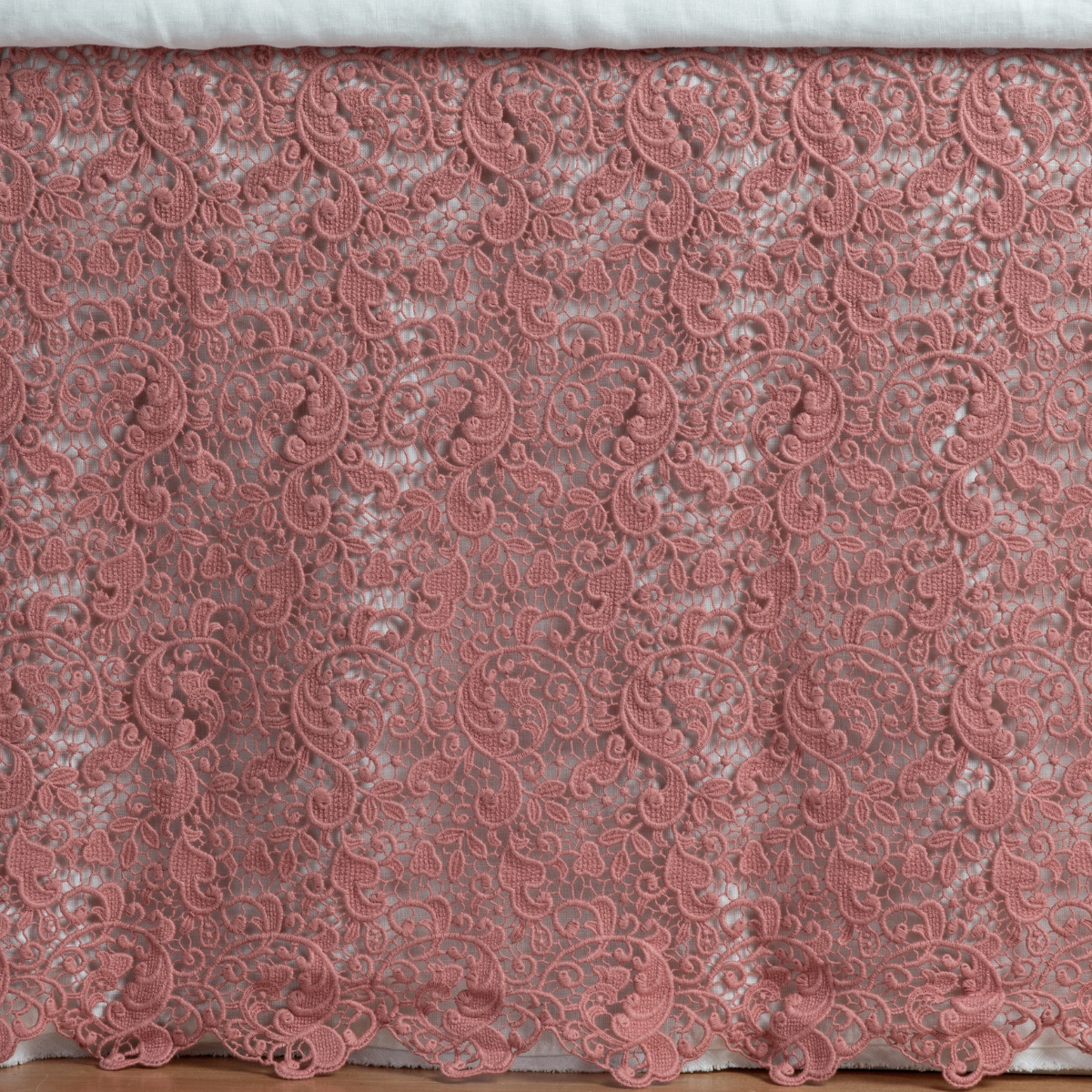 Poppy: a close up of a cotton lace bed skirt layered over a winter white bed skirt - shot straight at the bed skirt.