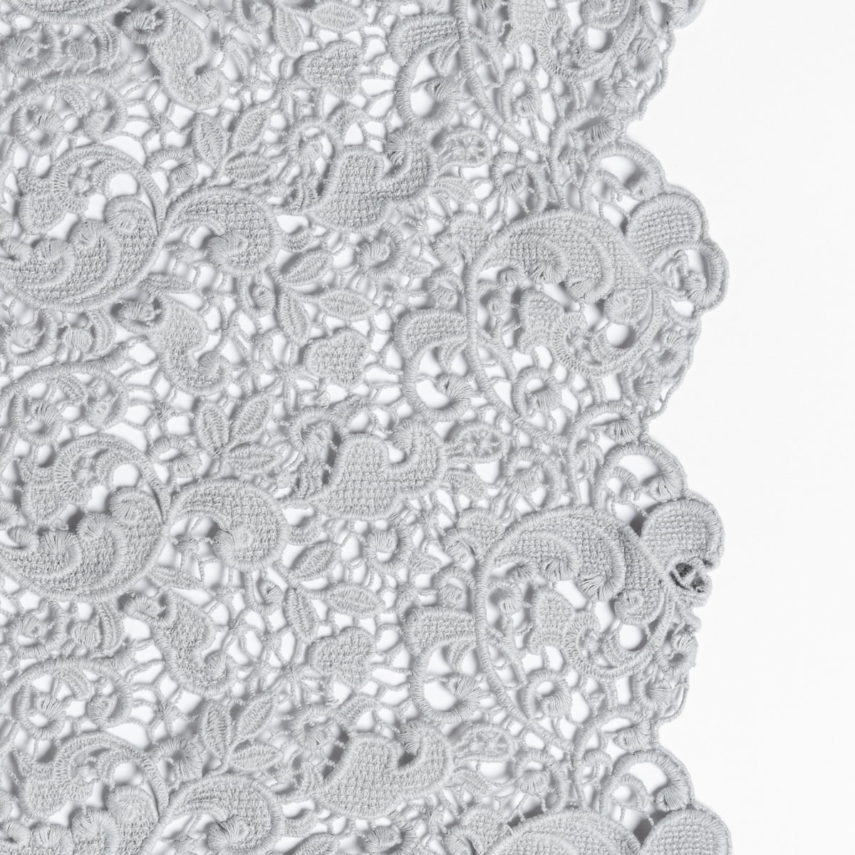 Cloud: a close up of cotton all-over lace with a scalloped edge.
