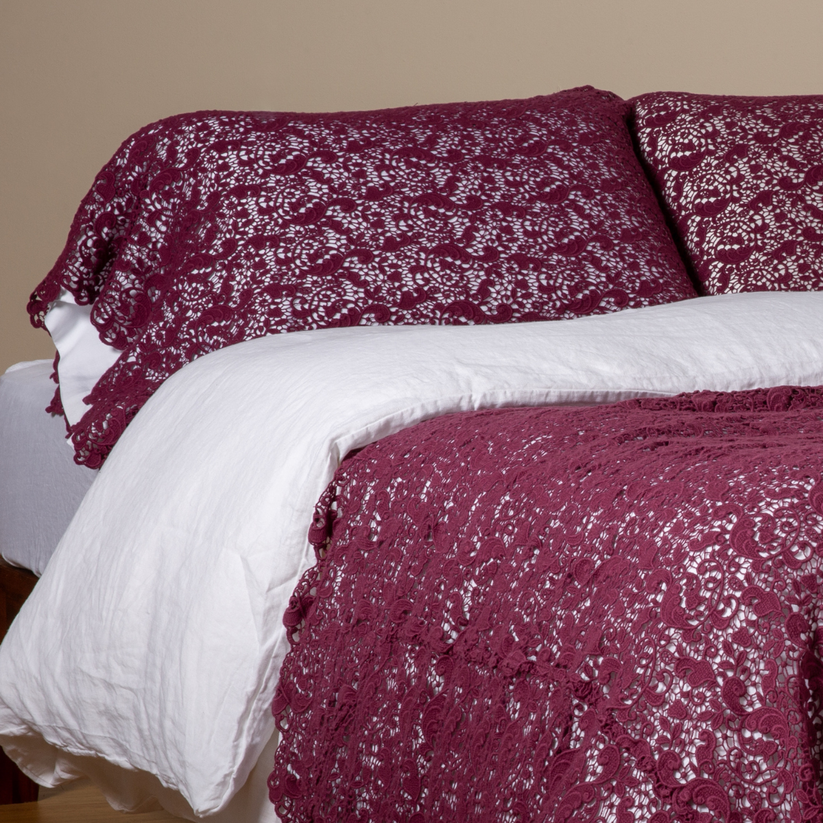 Fig: a pair of cotton lace pillowcase covers on winter white liners shown on a bed dressed in winter white linen with a matching cotton lace bed scarf.