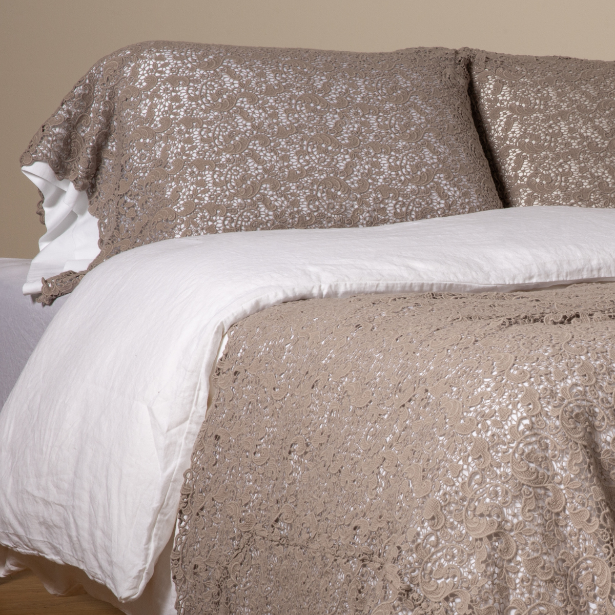 Fog: a pair of cotton lace pillowcase covers on winter white liners shown on a bed dressed in winter white linen with a matching cotton lace bed scarf.