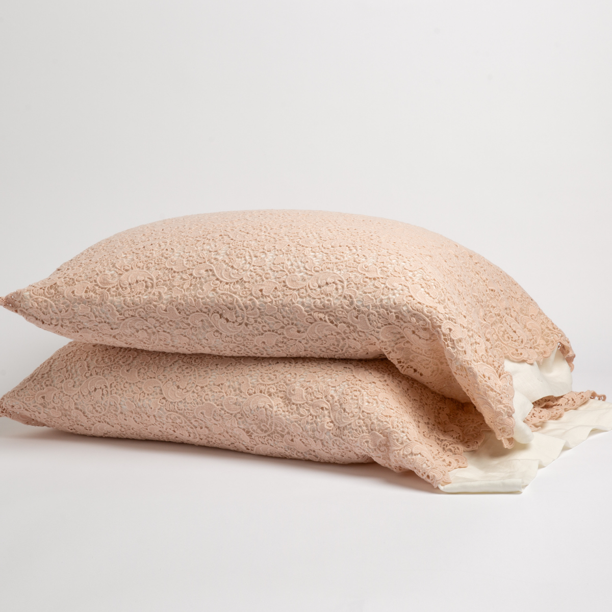 Pearl: a pair of stacked cotton lace pillowcase covers on winter white liners against a white background.