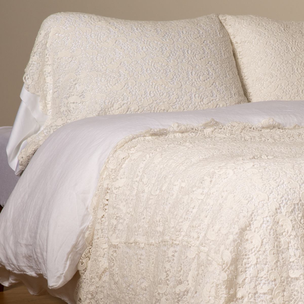 Winter White: a pair of cotton lace pillowcase covers on winter white liners shown on a bed dressed in winter white linen with a matching cotton lace bed scarf.