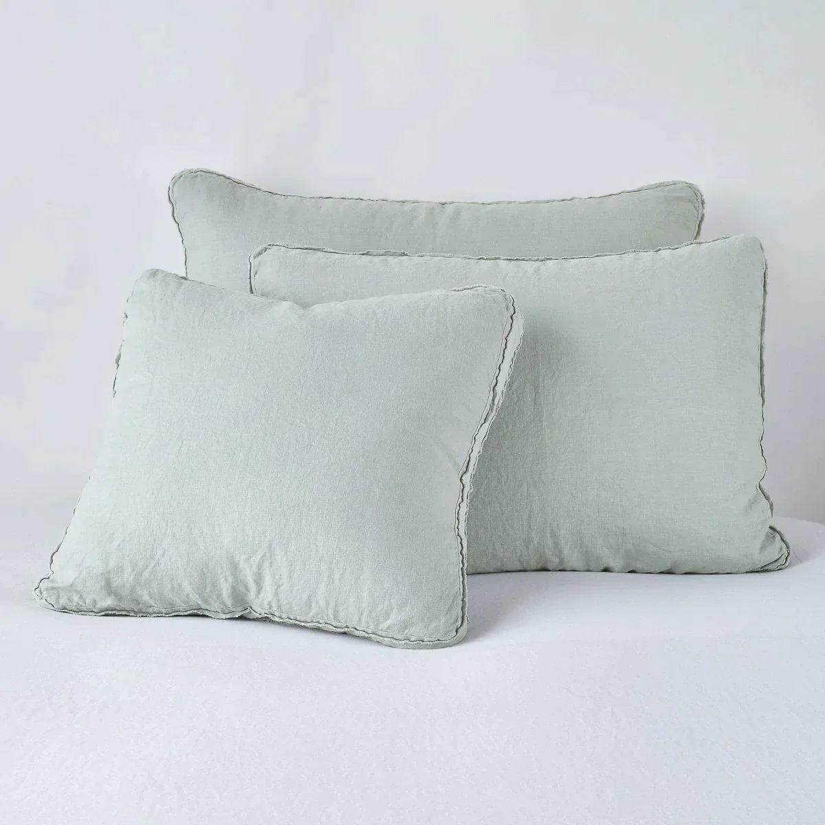 Eucalyptus: Midweight linen shams in eucalyptus colorway shown leaning upright on white background.