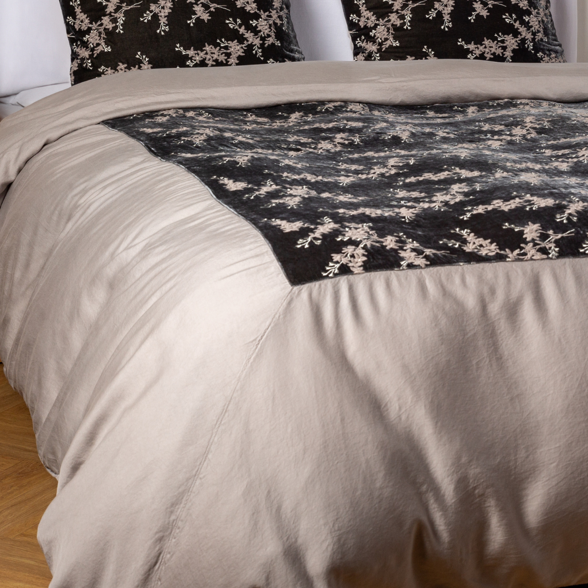 Fog: A close-up of the mitered corner of an embroidered silk velvet and tencel duvet cover — its matching shams barely visible in the shot.