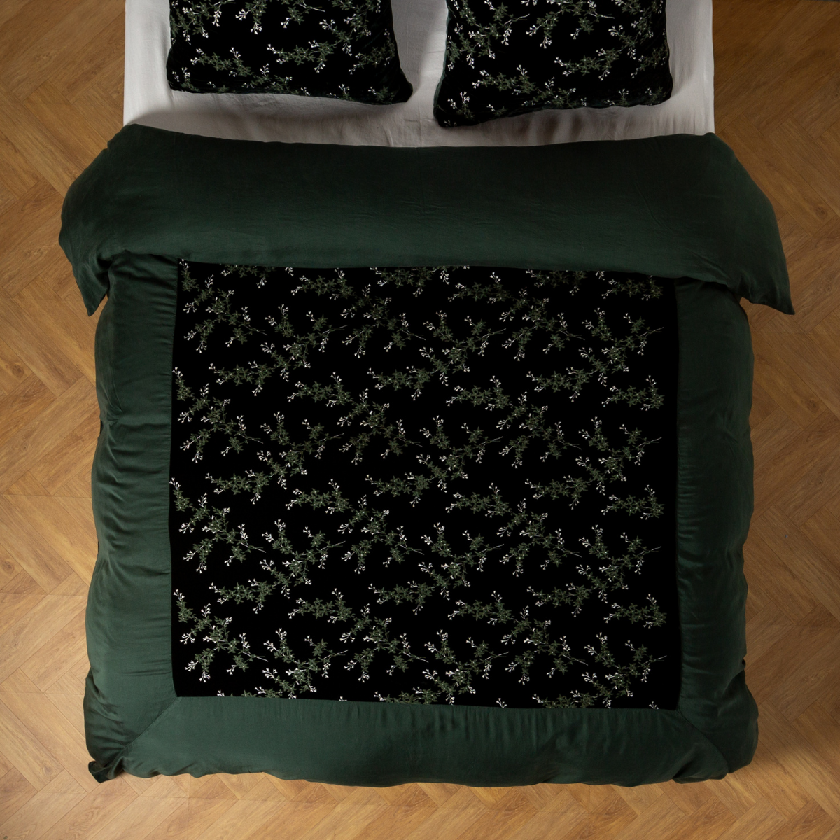 Juniper: An overhead shot of an embroidered silk velvet and tencel duvet cover and matching shams.