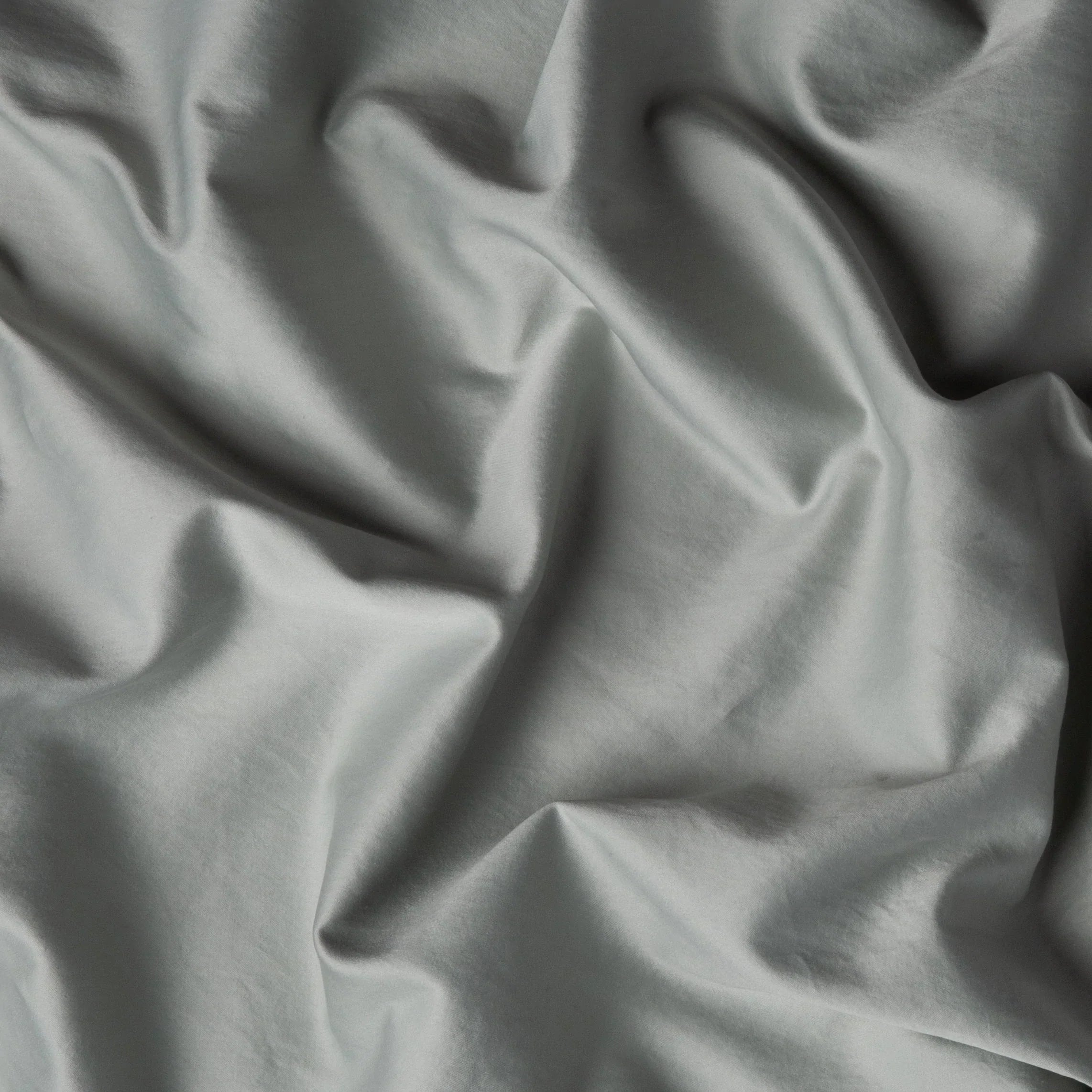 Eucalyptus: A close up of cotton sateen fabric in eucalyptus, a soft light green.