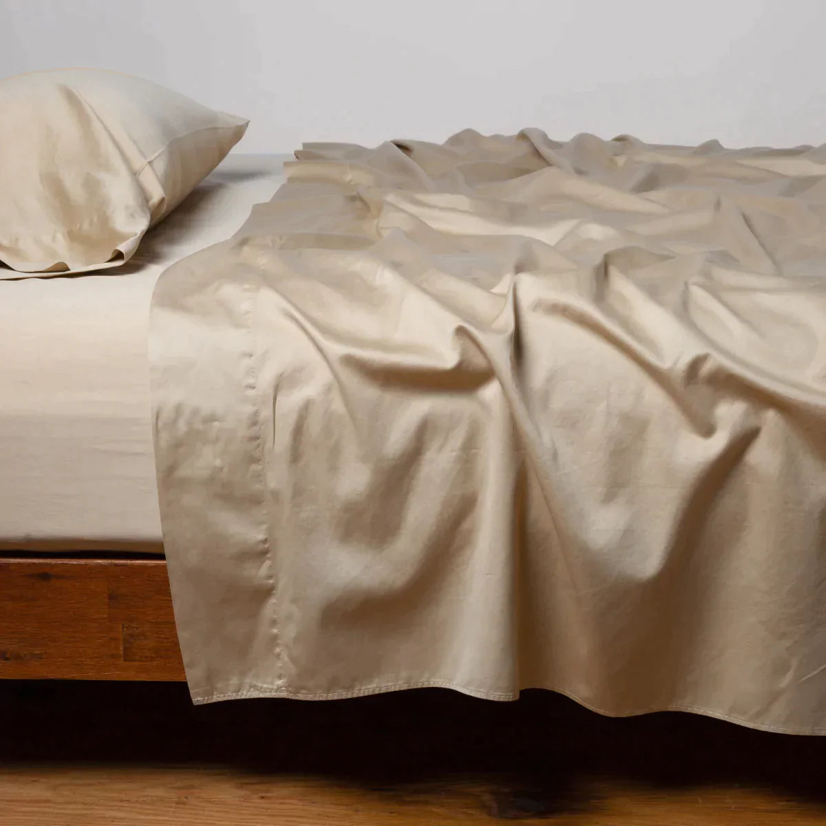 Honeycomb: Cotton sateen flat sheet, shown with matching fitted sheet and sleeping pillow - side view.