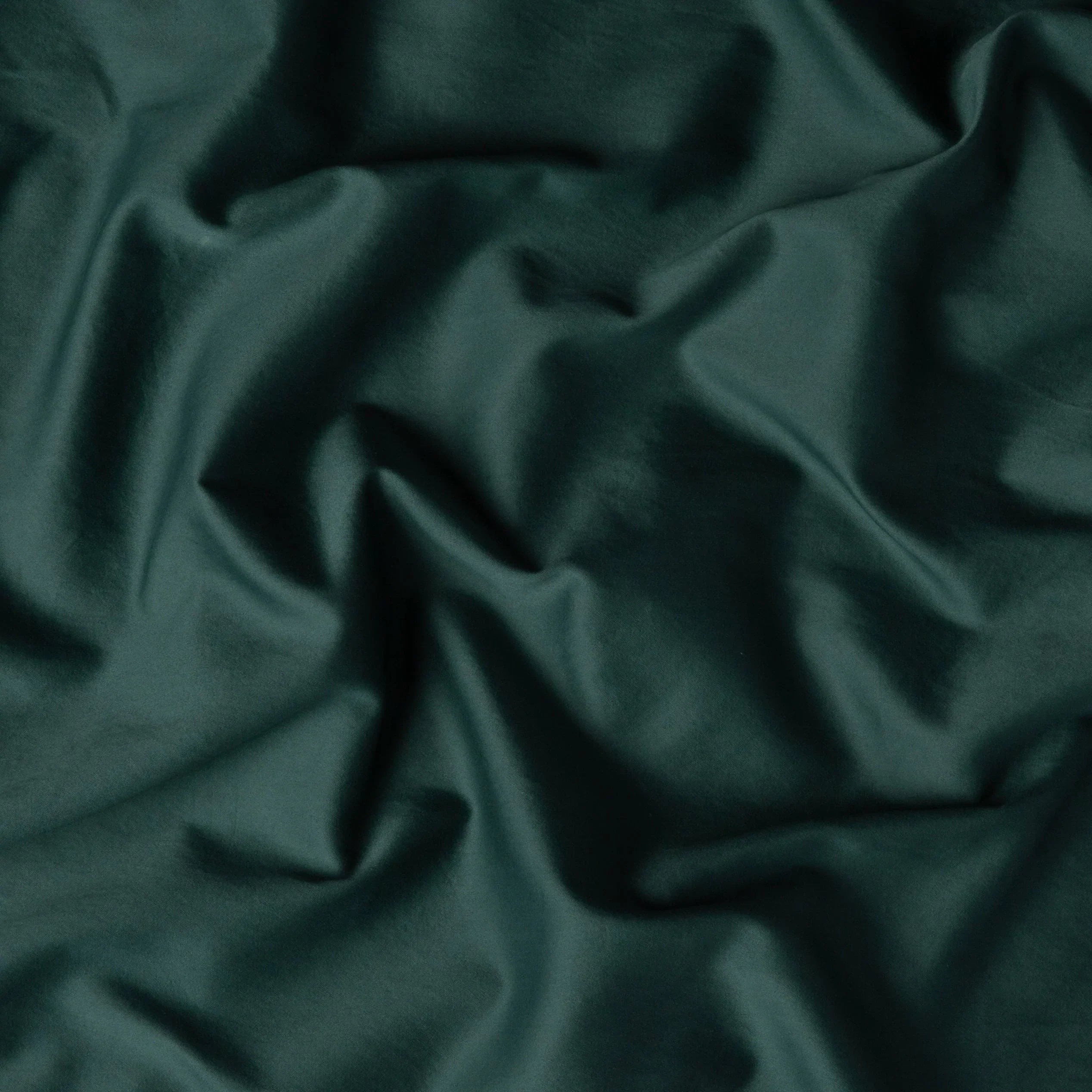 Jade: A close up of cotton sateen fabric in jade, a rich, verdant green with subtle blue undertones.