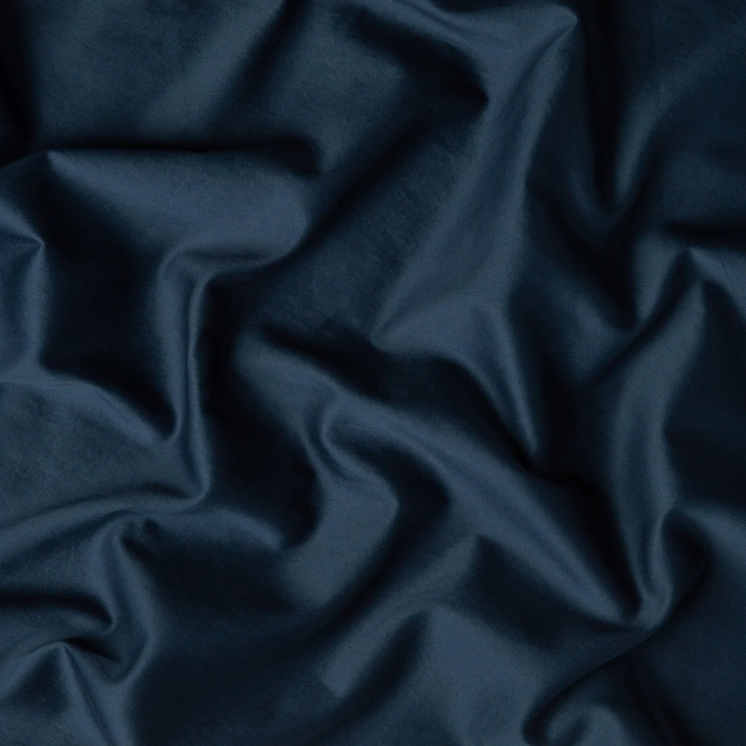 Midnight: A close up of cotton sateen fabric in midnight, a rich indigo tone.