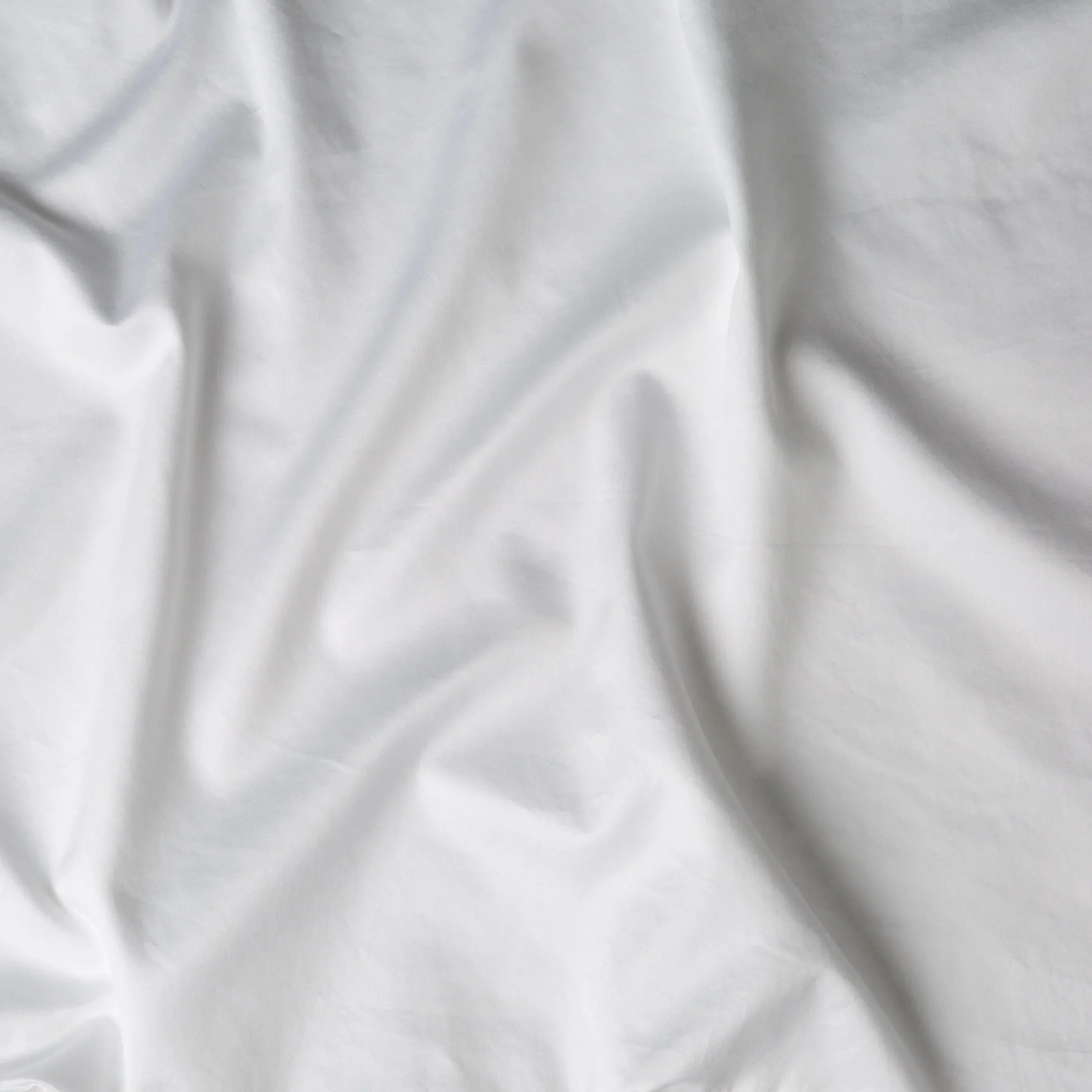White: A close up of cotton sateen fabric in white.