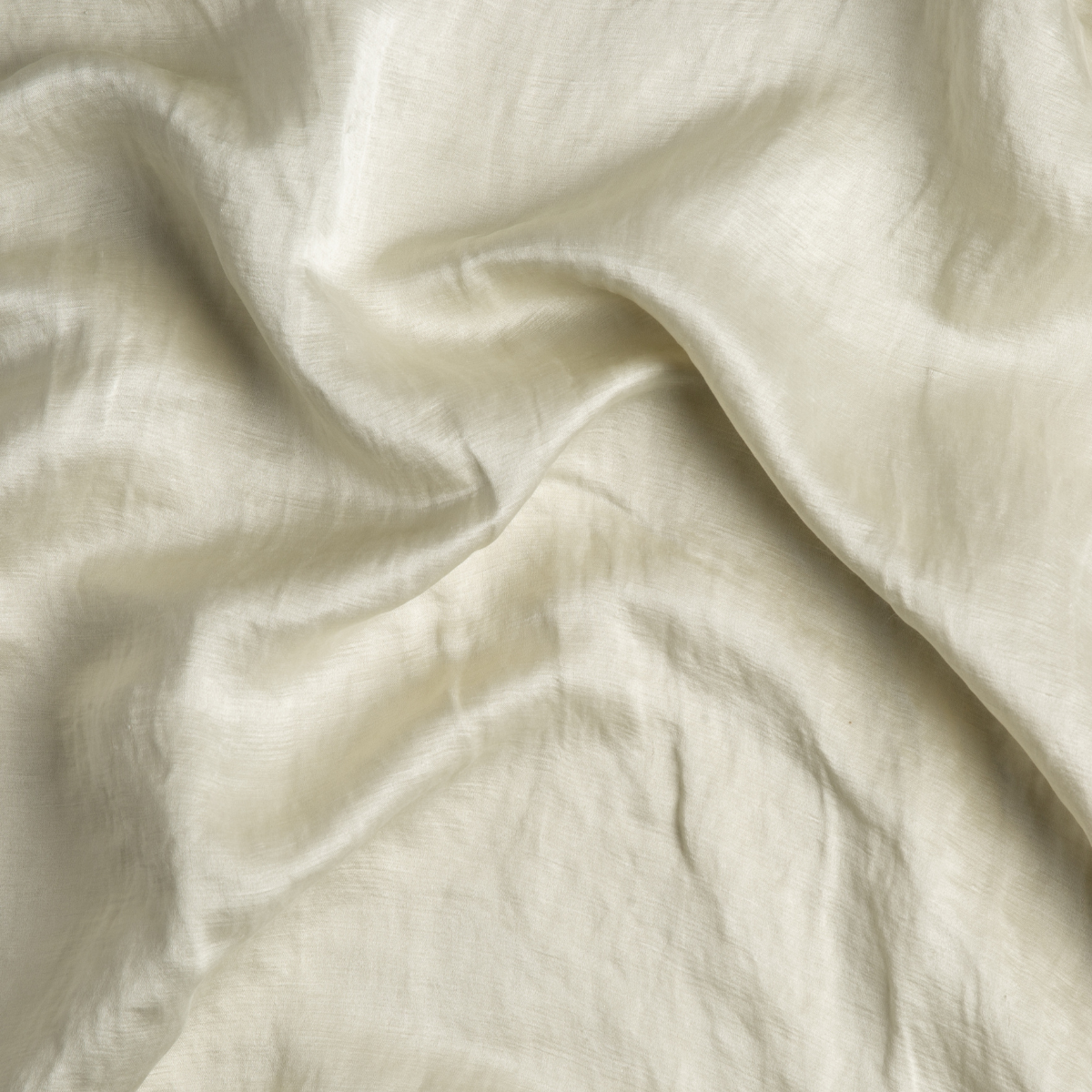 Parchment: A close up of charmeuse fabric in parchment, a warm, antiqued cream.