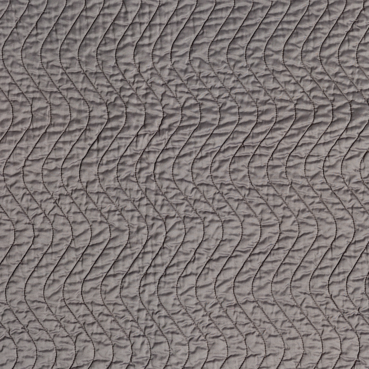 Fig: A close up of quilted cotton sateen fabric in fig, a richly saturated purple-garnet.