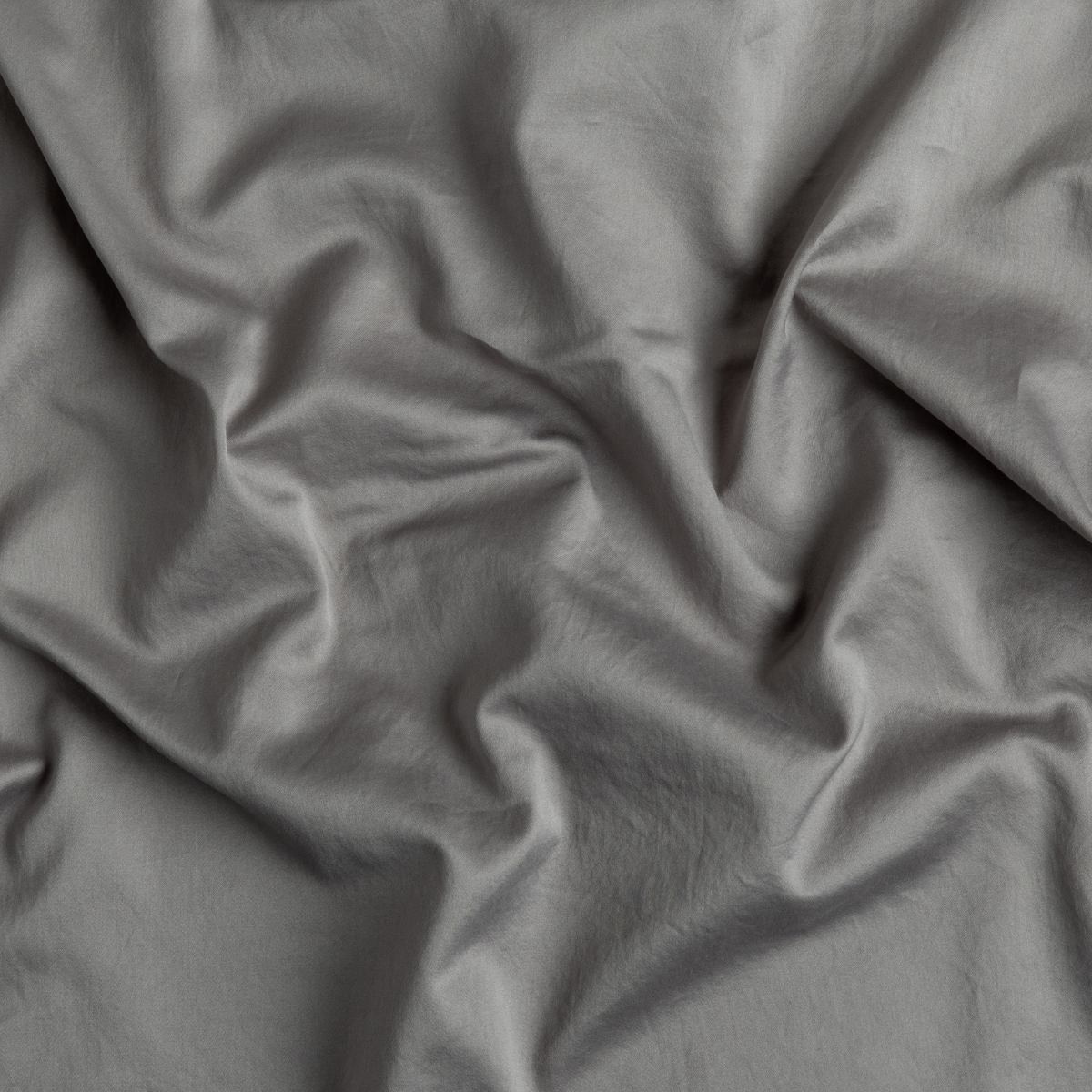 Moonlight: A close up of cotton sateen fabric in moonlight, a saturated, cool, mid-dark grey tone.