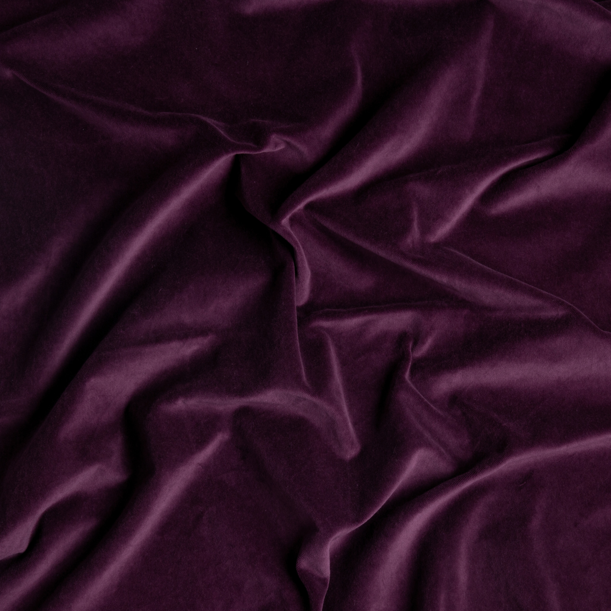 Fig: A close up of cotton velvet fabric in fig, a richly saturated purple-garnet.