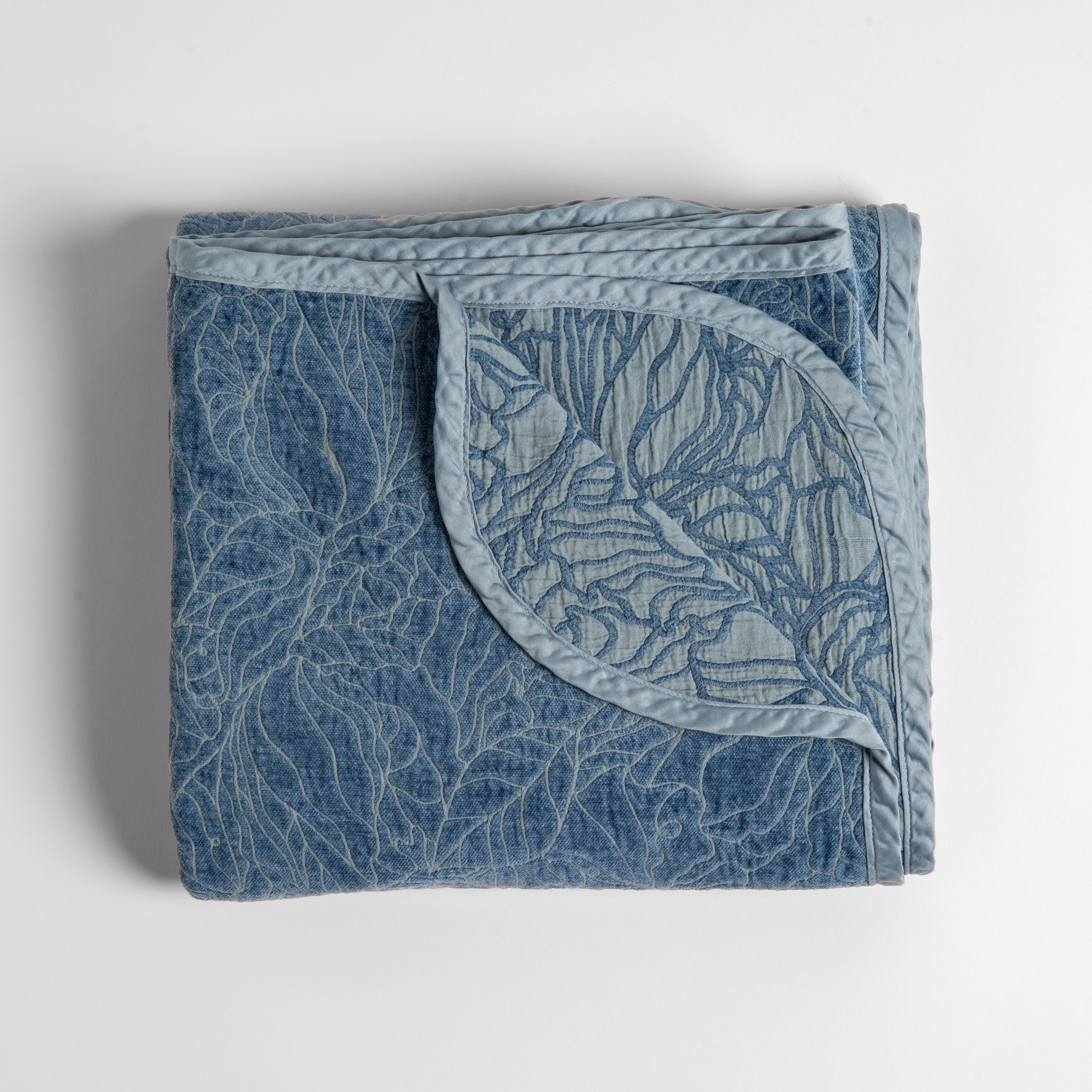 Tahoe Blue: folded blanket with its cotton jacquard side visible on the corner foldback against the chenille jacquard side.