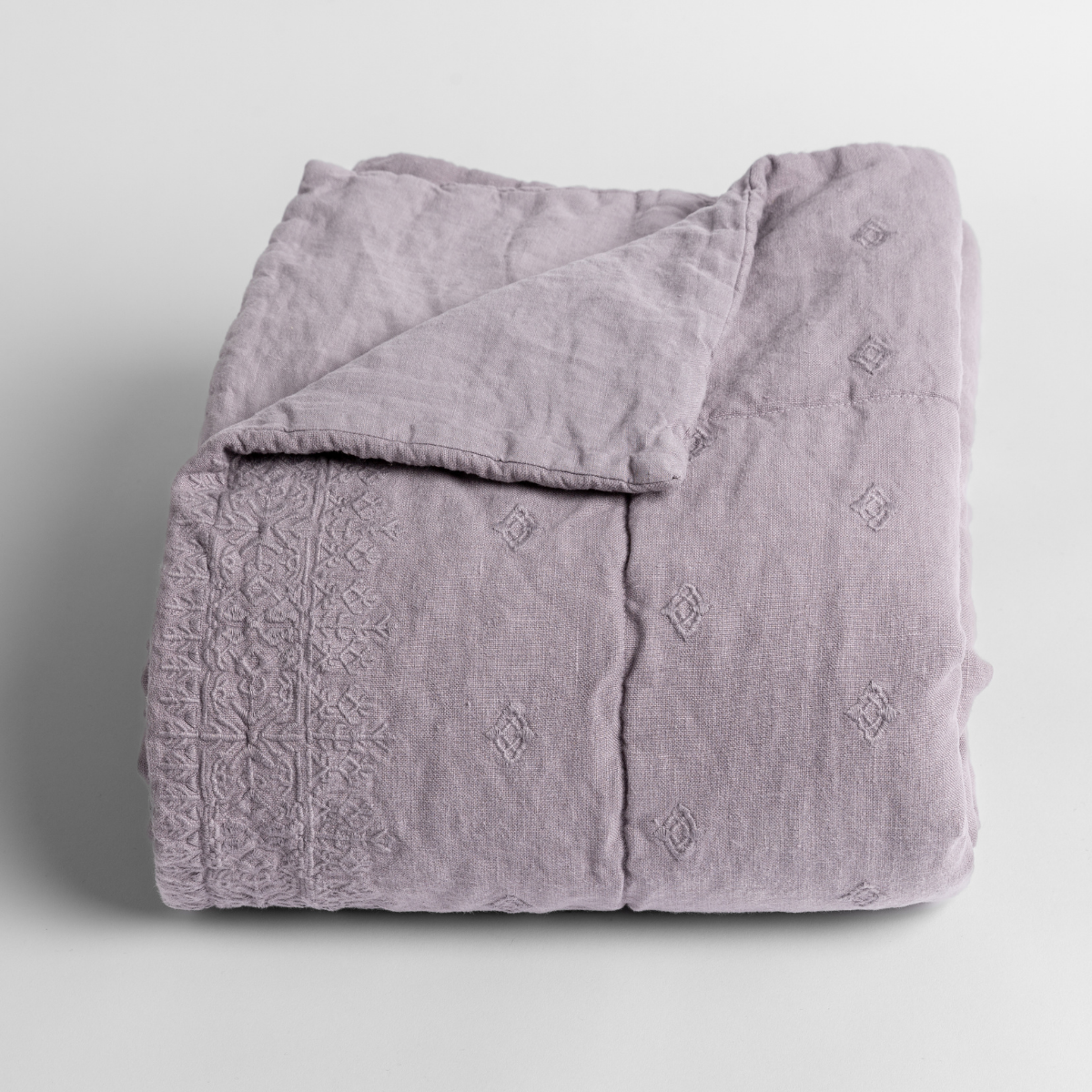 French Lavender: embroidered midweight linen baby blanket folded and shown with the corner folded down to show the unembroidered linen back.