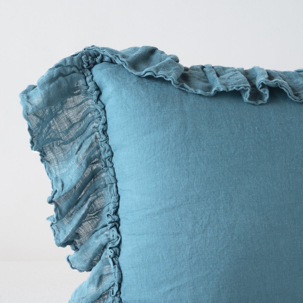 : Corner detail close-up of Linen Whisper sham, showcasing slight translucence of ruffle trim detail - cenote.