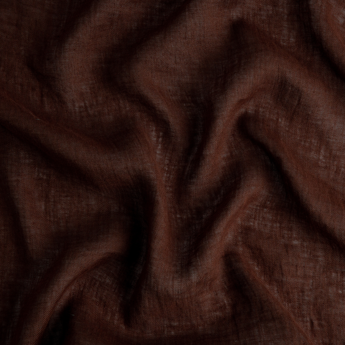 A close up of linen whisper, our lightweight linen gauze, in mahogany, a deep, earthen, reddish brown.