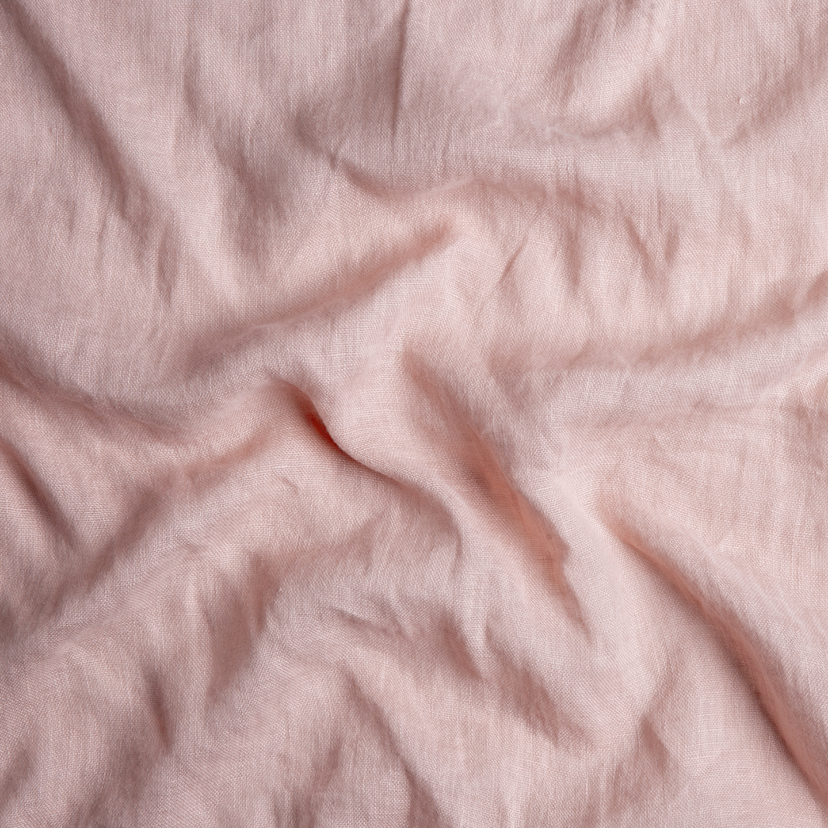 Rouge: A close up of linen whisper fabric in rouge, a mid-tone blush pink.