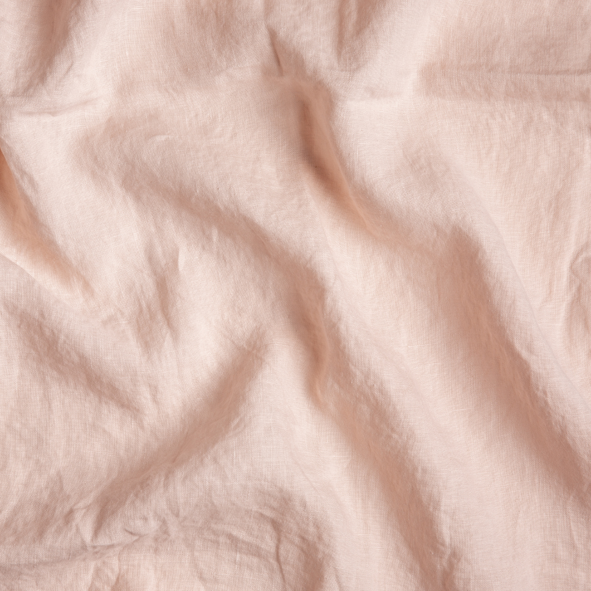 Pearl: A close up of linen fabric in pearl, a nude-like, soft rose pink tone.