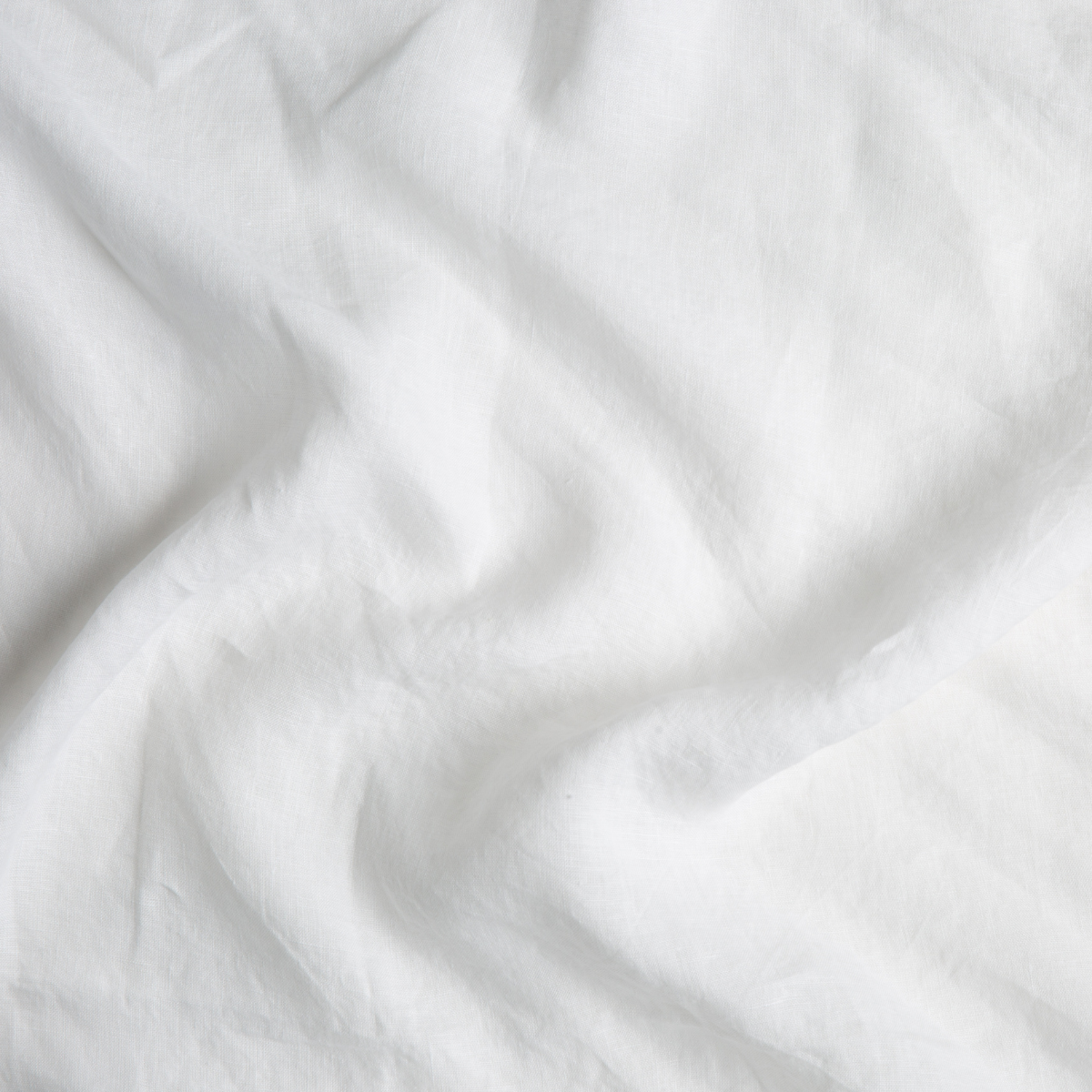 Winter White: A close up of linen fabric in winter white, softer and warmer in tone than classic white.