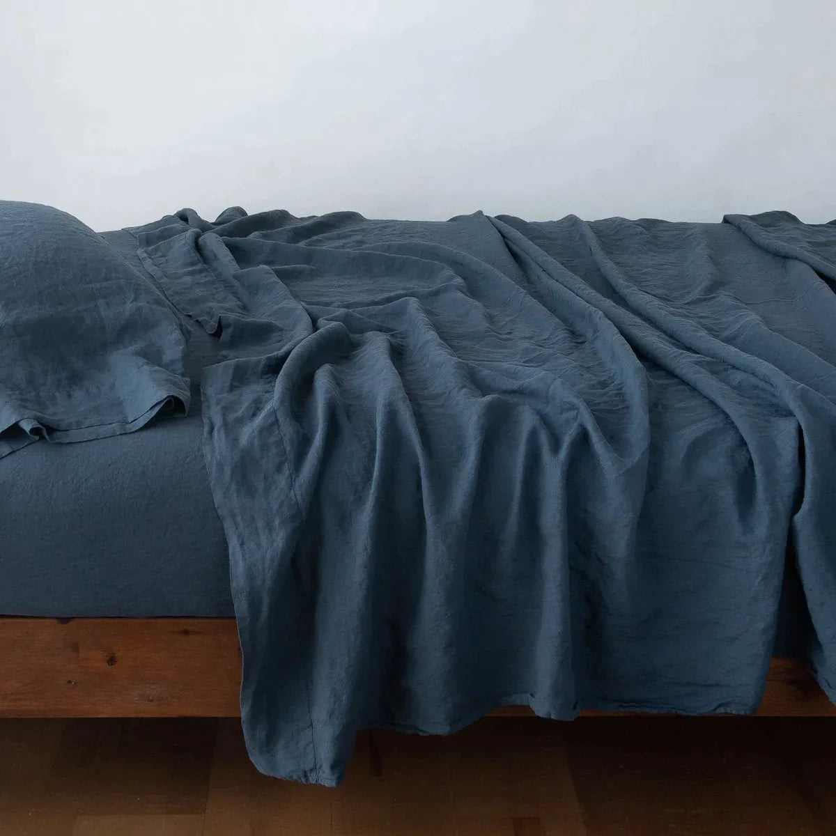 Midnight: Rumpled linen sheeting with matching sleeping pillow - side view.
