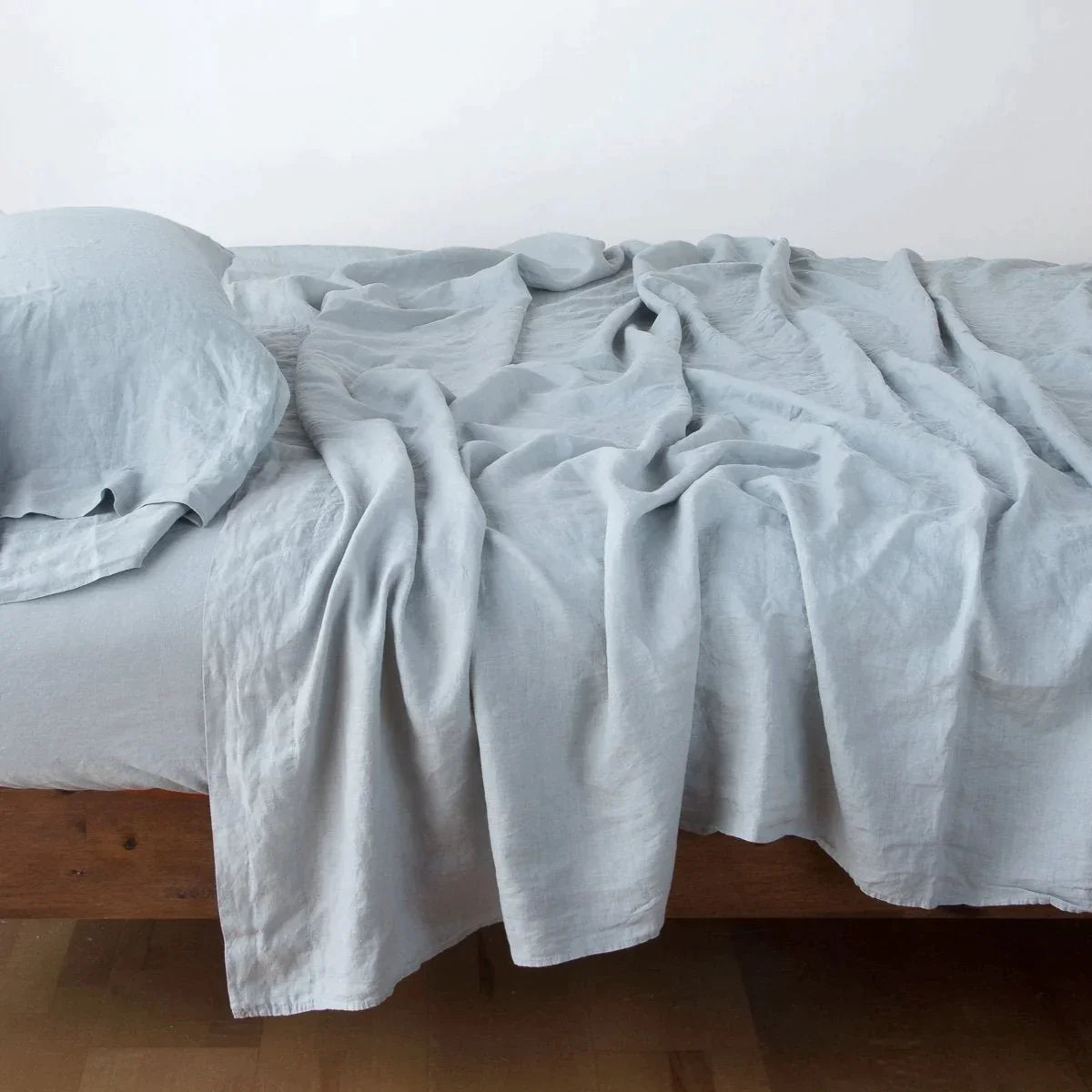 Mineral: Rumpled linen sheeting with matching sleeping pillow - side view.