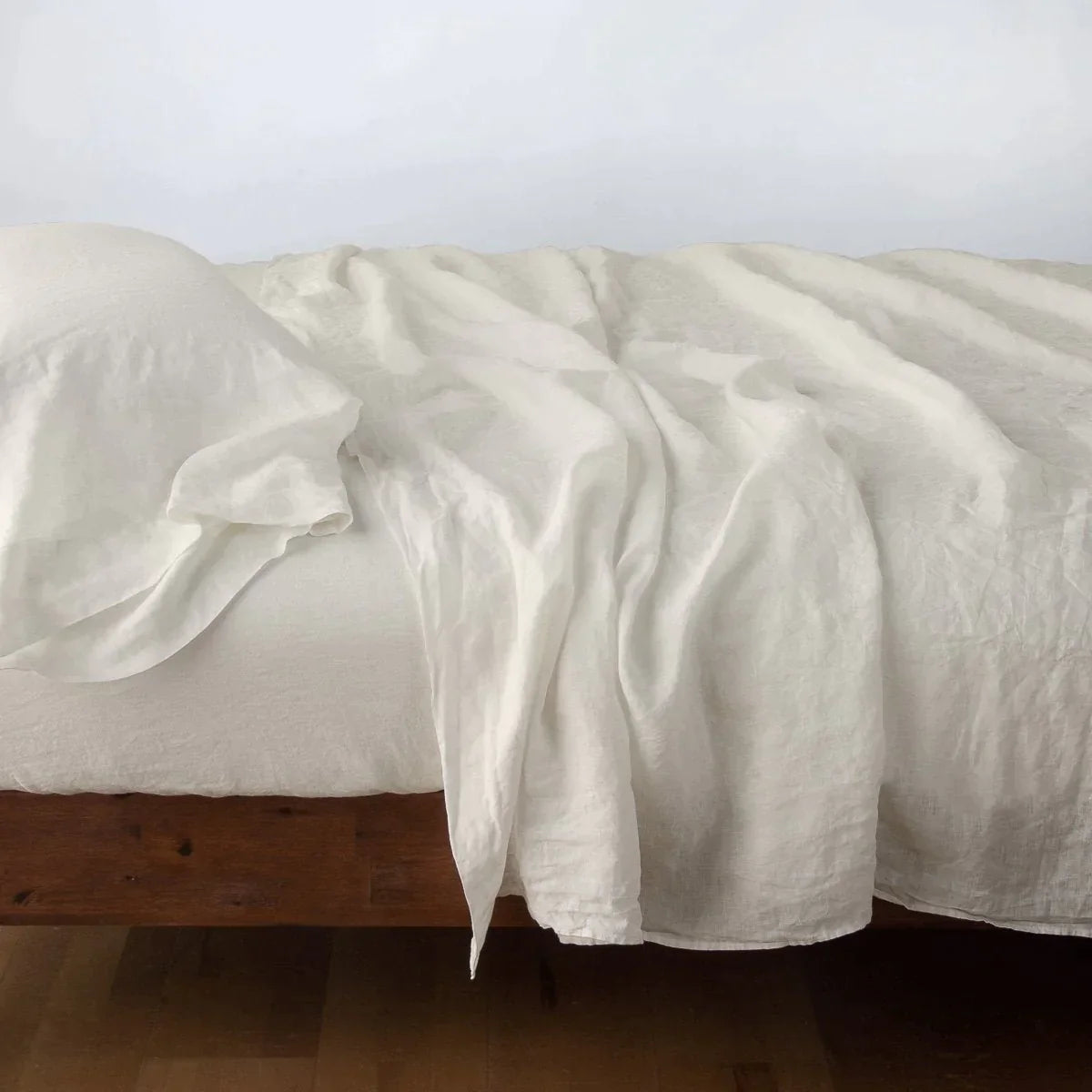 Parchment: Rumpled linen sheeting with matching sleeping pillow - side view.