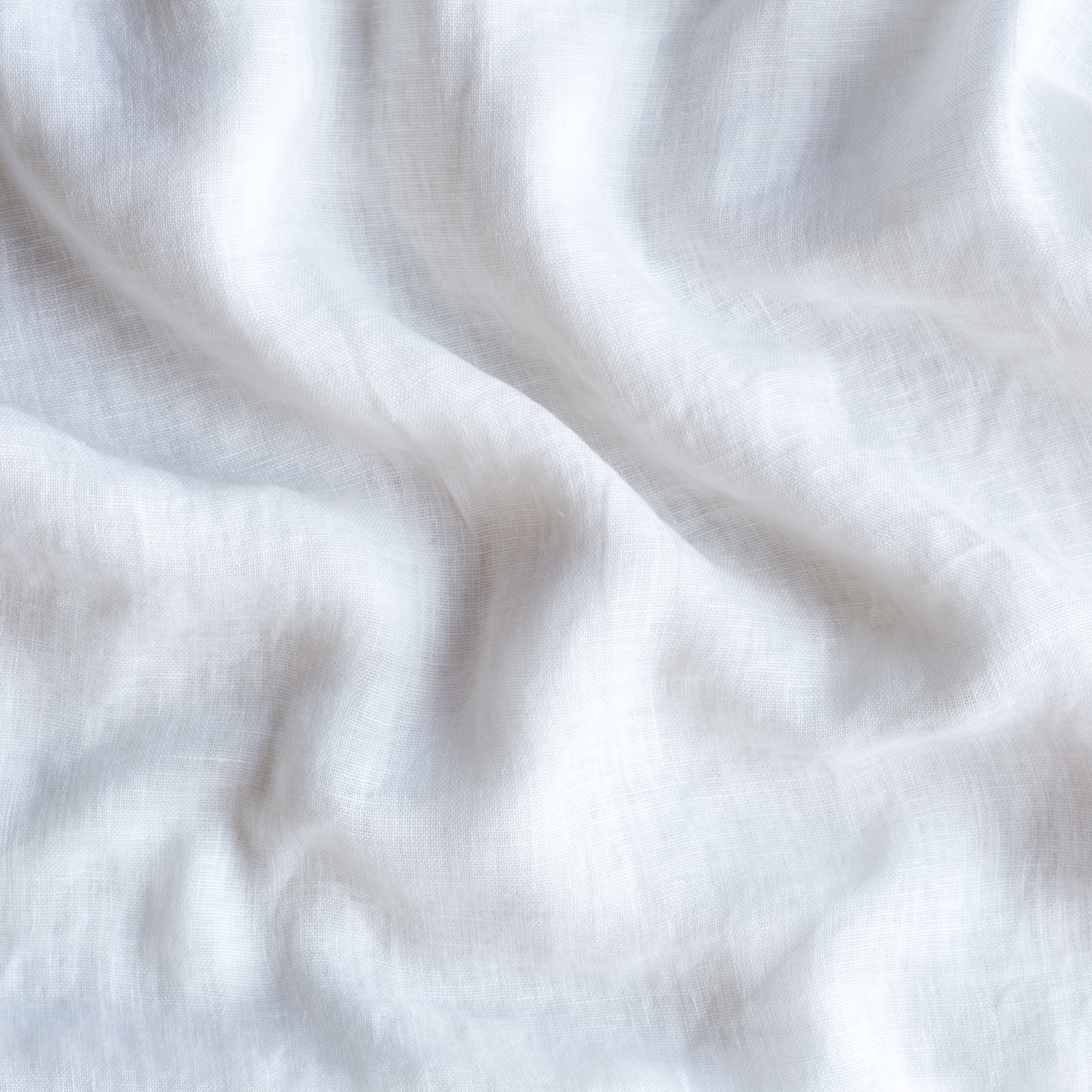 Winter White: A close up of linen whisper, our lightweight linen gauze, in winter white, softer and warmer in tone than classic white.