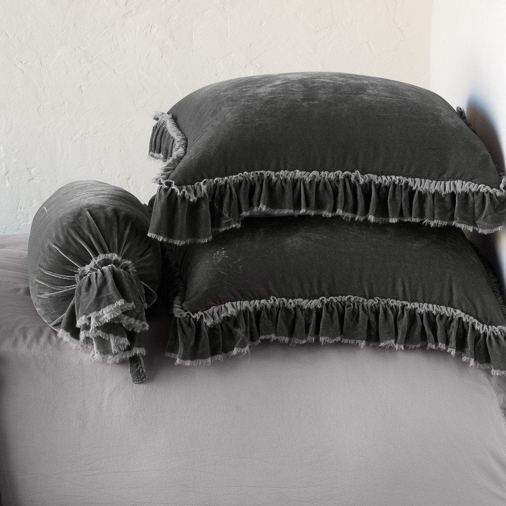 Fog: Two shams stacked flat next to matching bolster. Close-up side view highlights the ruffle trim.