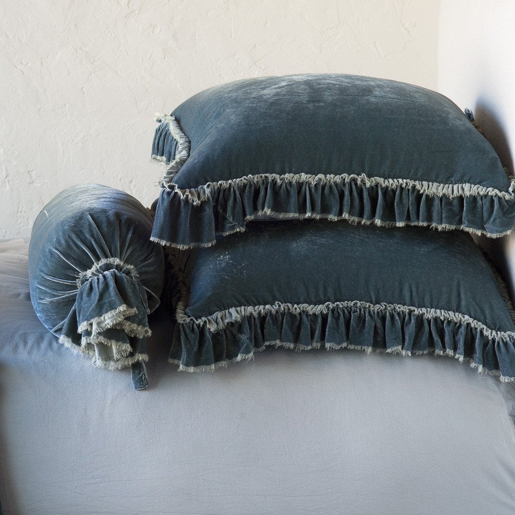 Mineral: Two shams stacked flat next to matching bolster. Close-up side view highlights the ruffle trim.