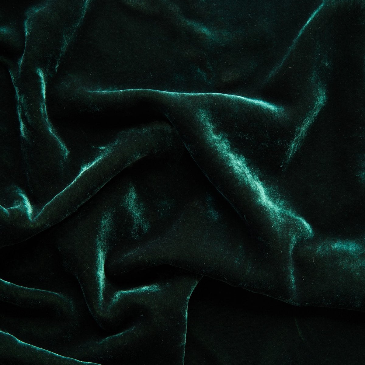 A close up of silk velvet in jade, a rich, verdant green with subtle blue undertones.