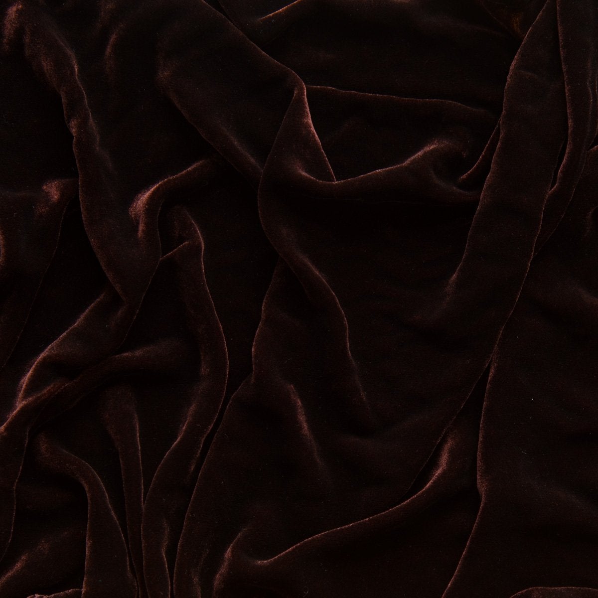A close up of silk velvet in mahogany, a rich earthen brown.