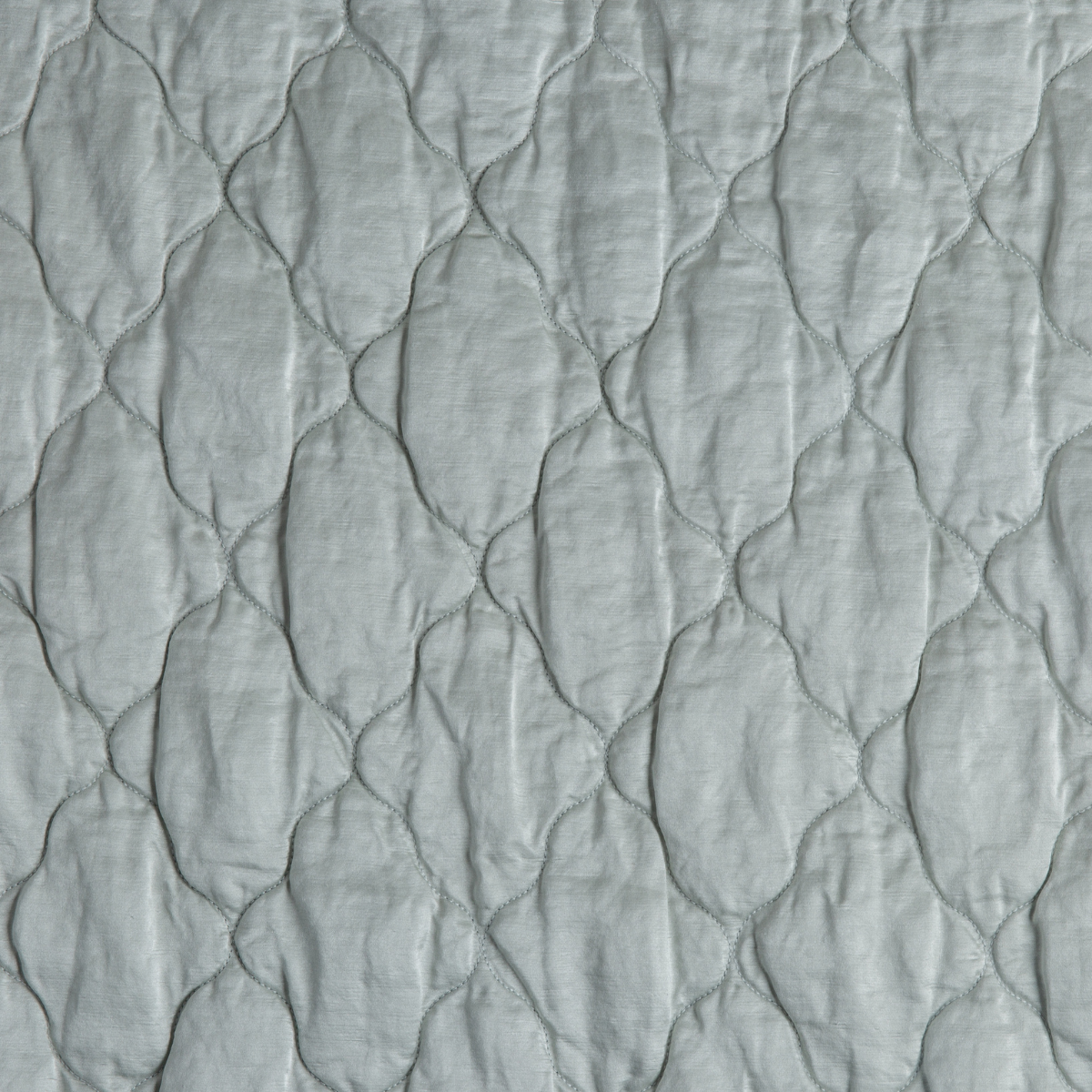 Cloud: A close up of quilted charmeuse fabric in cloud, a soft, subtle sky blue-grey.