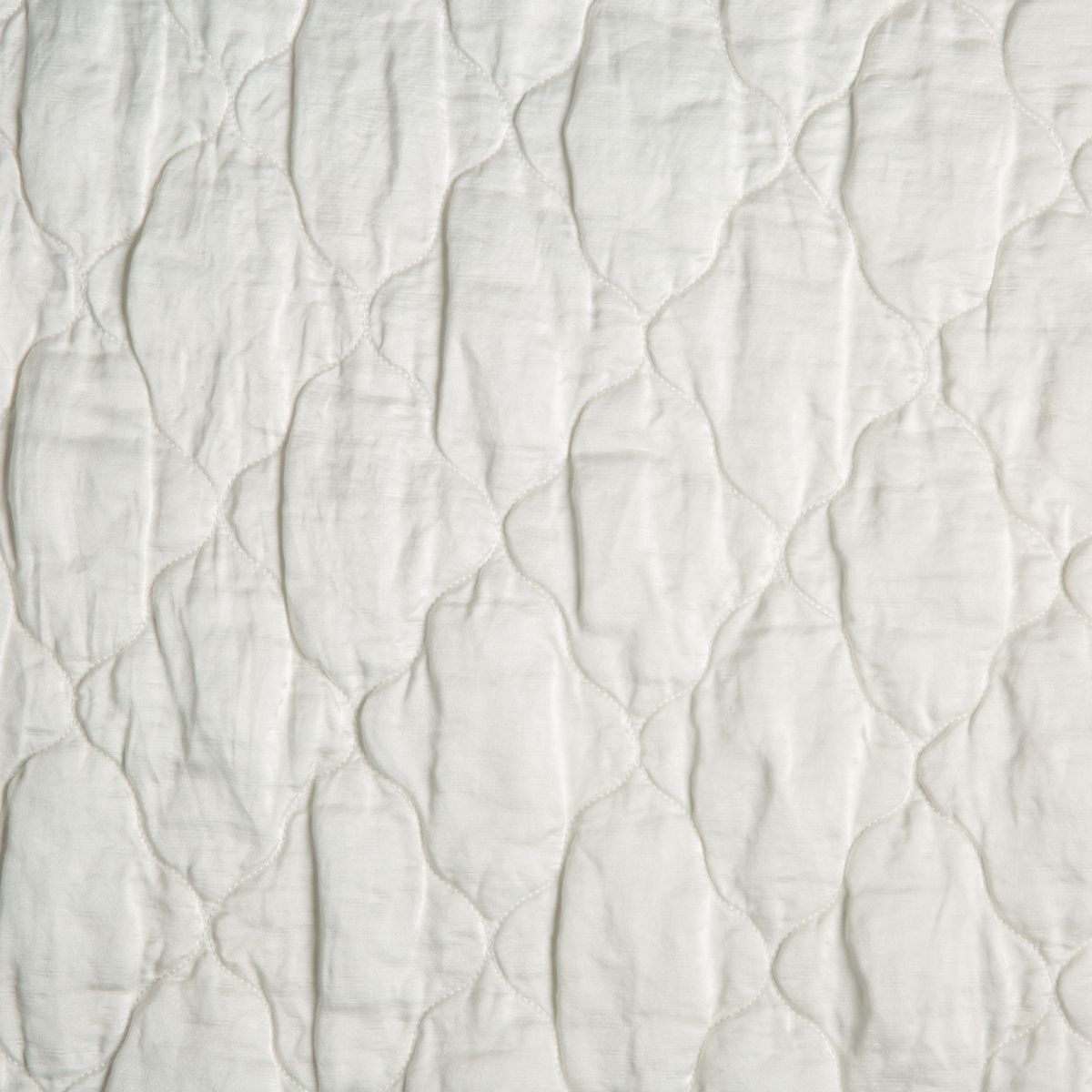 Winter White: A close up of quilted charmeuse fabric in winter white, softer and warmer in tone than classic white.