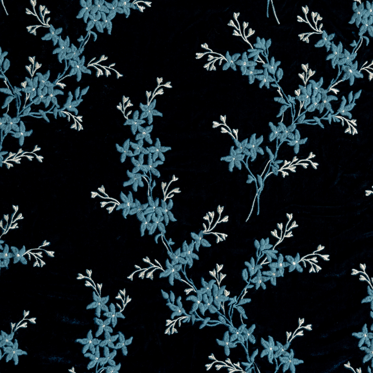 Cenote: A close up of embroidered silk velvet fabric in cenote, a vibrant, ocean-inspired blue-green.