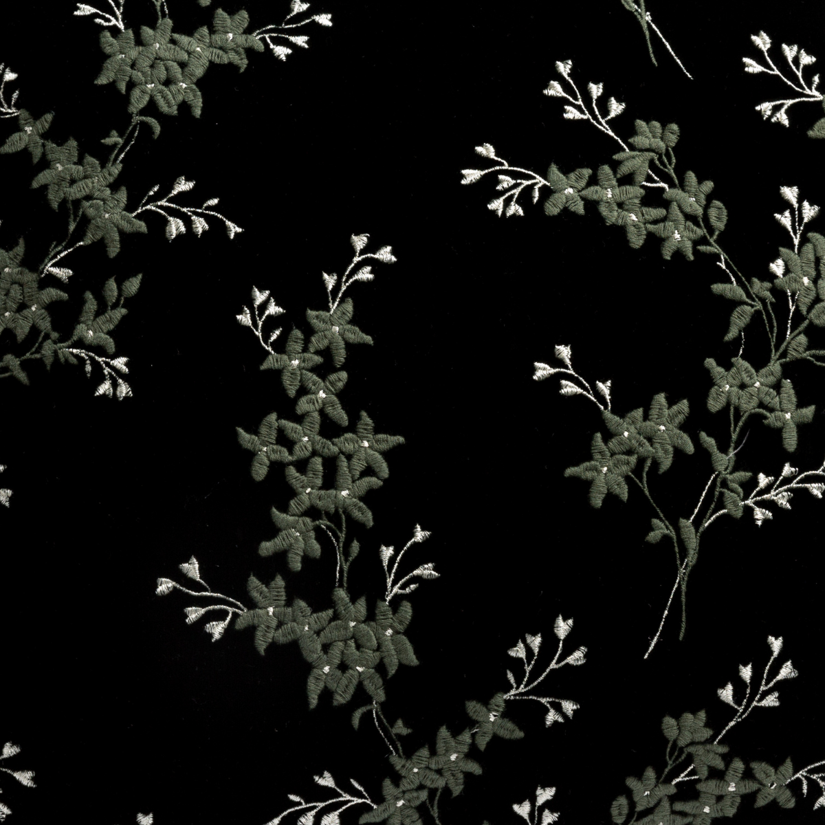 Juniper: A close up of embroidered silk velvet fabric in Juniper, a deep green tone.