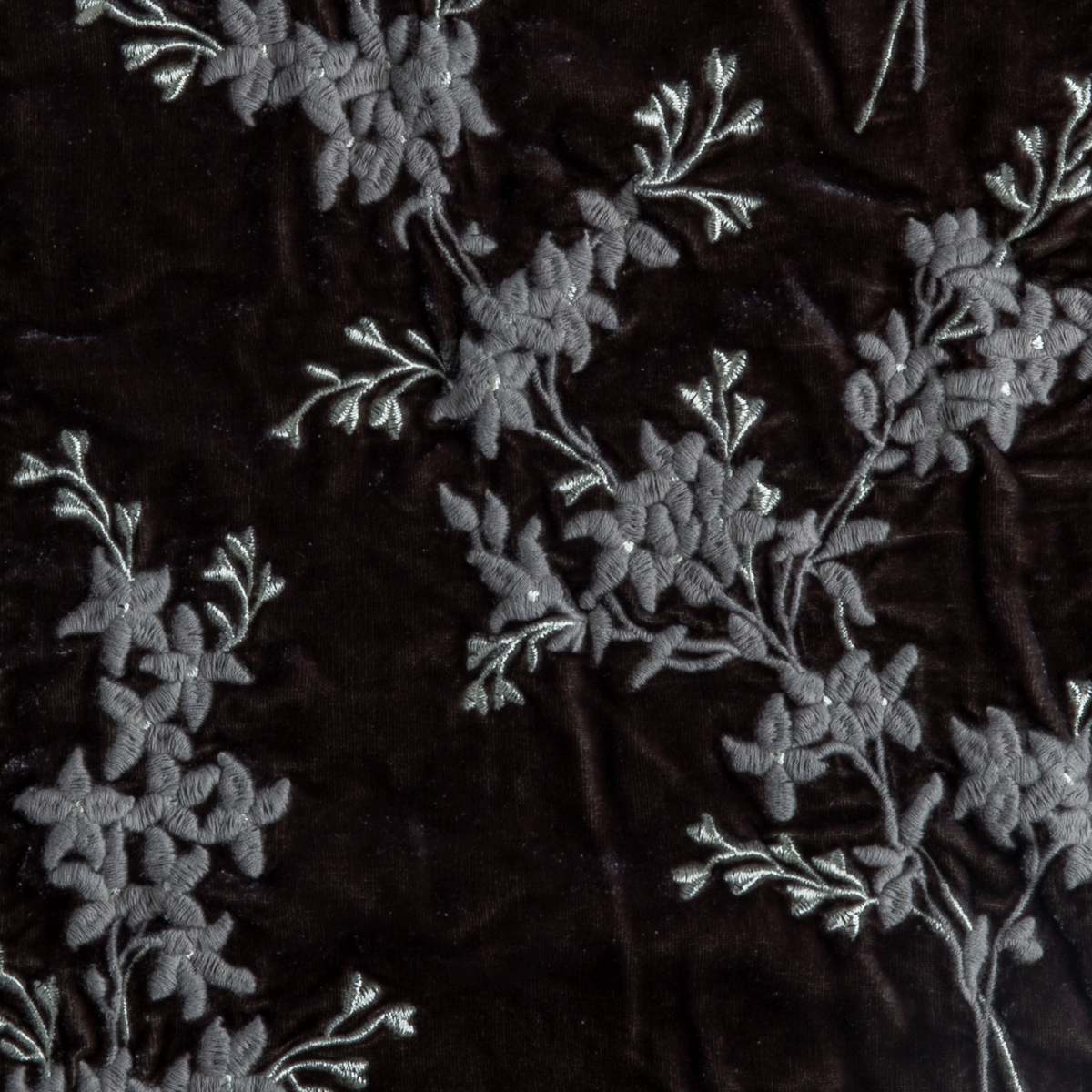 Moonlight: A close up of embroidered silk velvet fabric in moonlight, a saturated, cool, mid-dark grey tone.