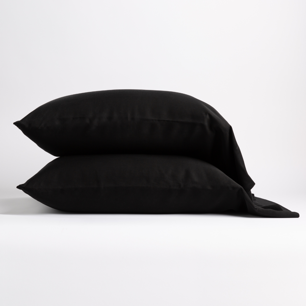 Corvino: sleeping pillows stacked neatly against a white backdrop - side view.