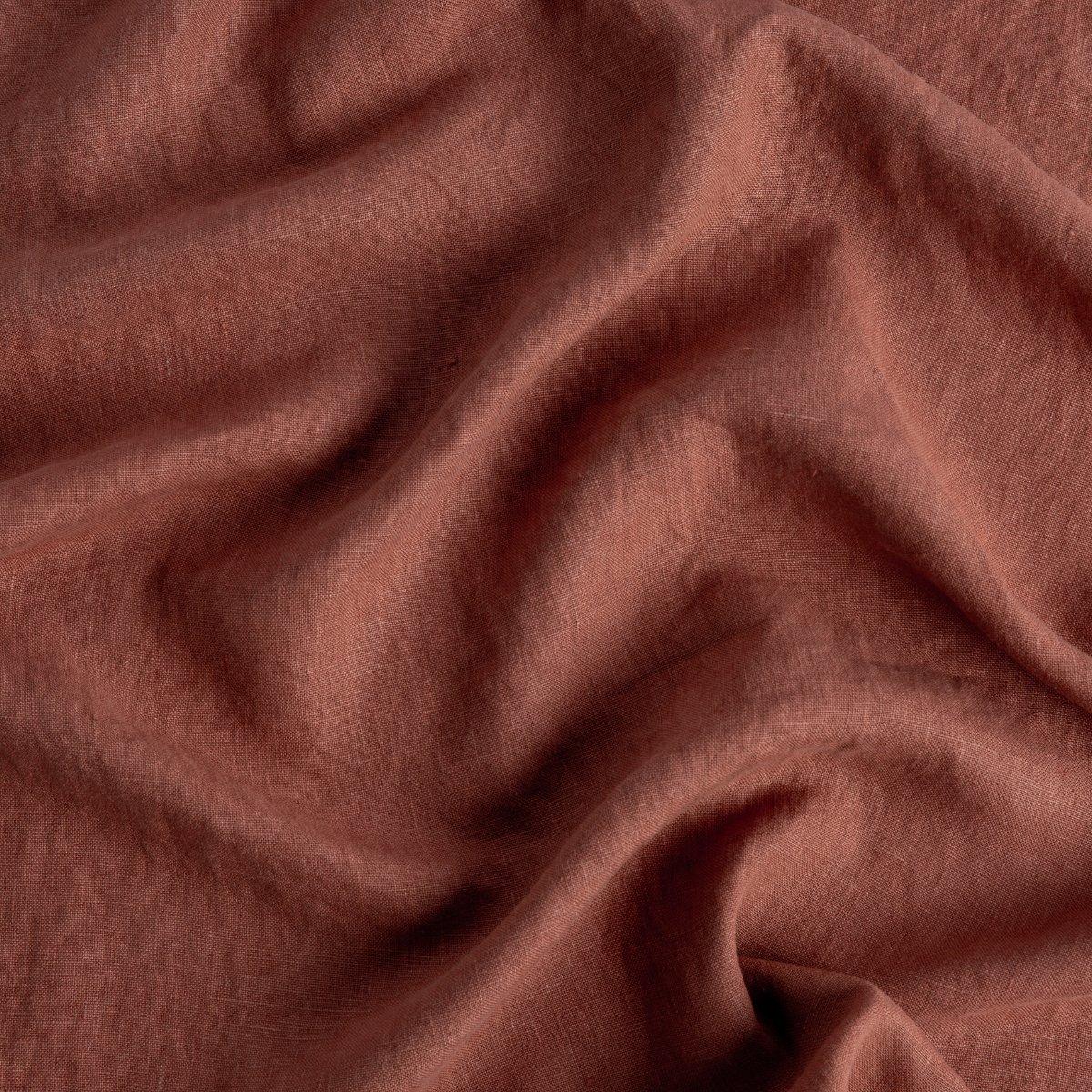 Autumn: Bella Notte Midweight Linen in Autumn, a rust color, close up and gently rumpled.