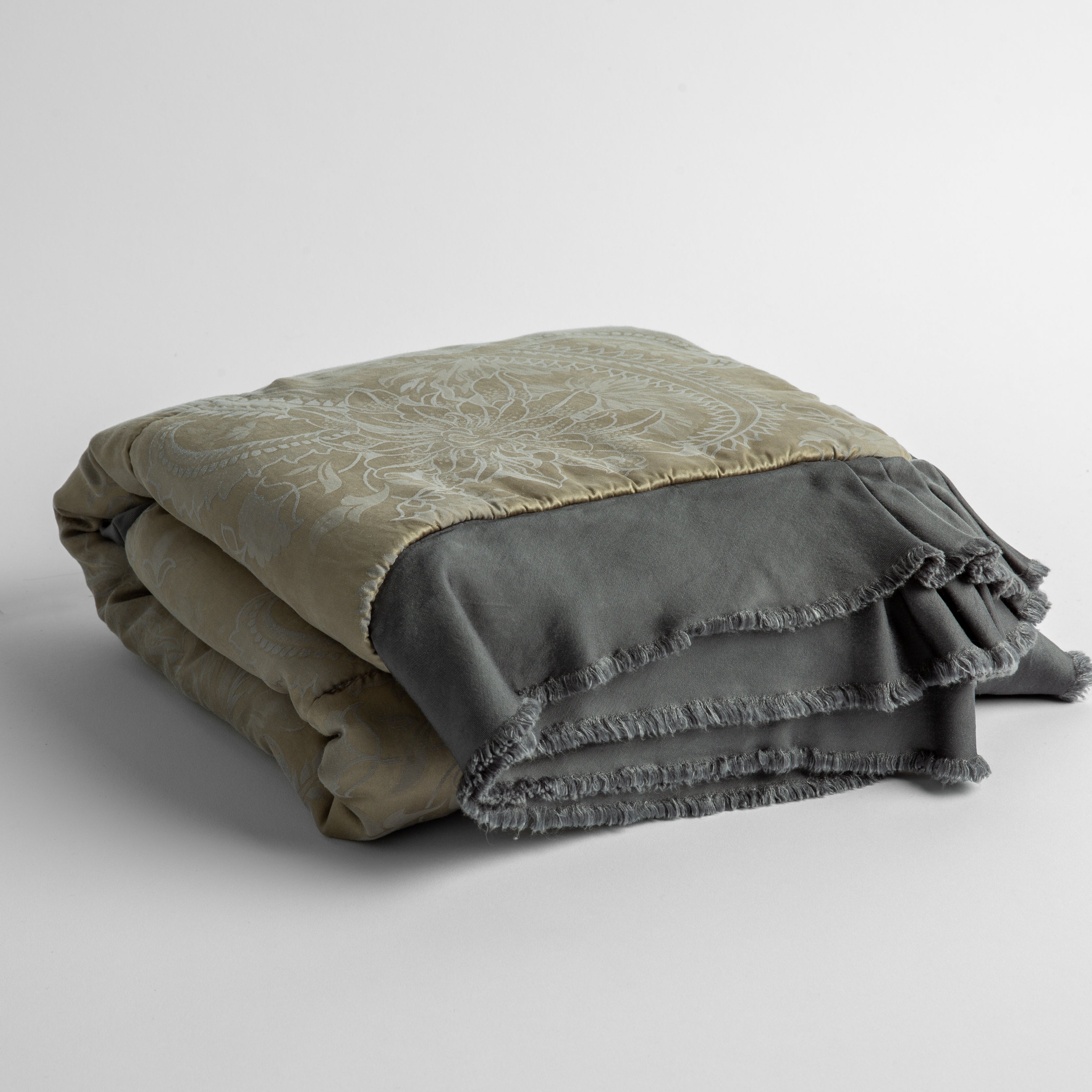 Moonlight: a silk and tencel™ jacquard baby blanket folded and shot against a white background with the ruffled trim situated to be visible