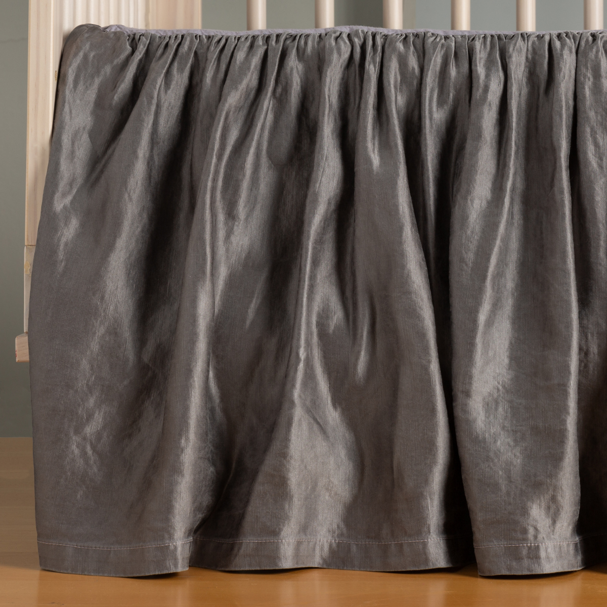 French Lavender: charmeuse crib skirt on a crib without a mattress, the skirt gently skimming the floor.