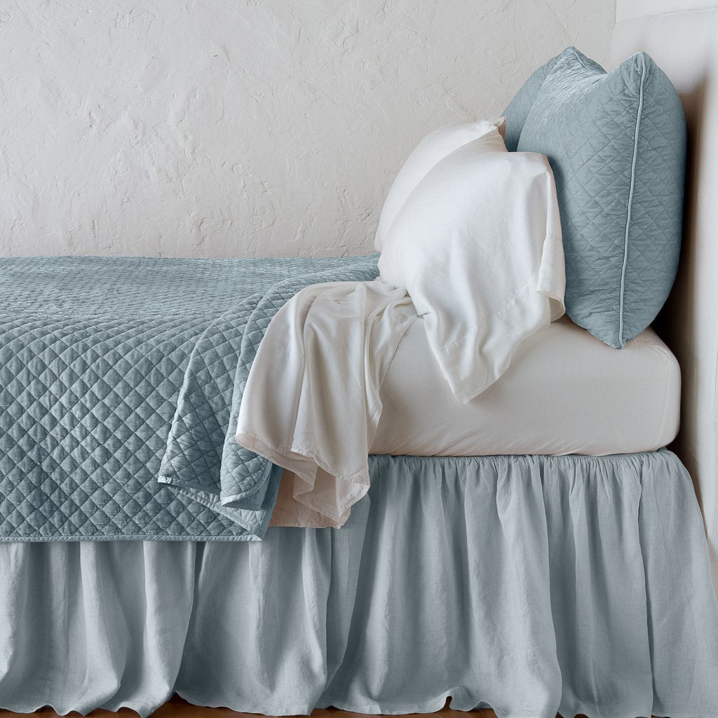 Cloud: coverlet with matching shams and white sheeting - side view.