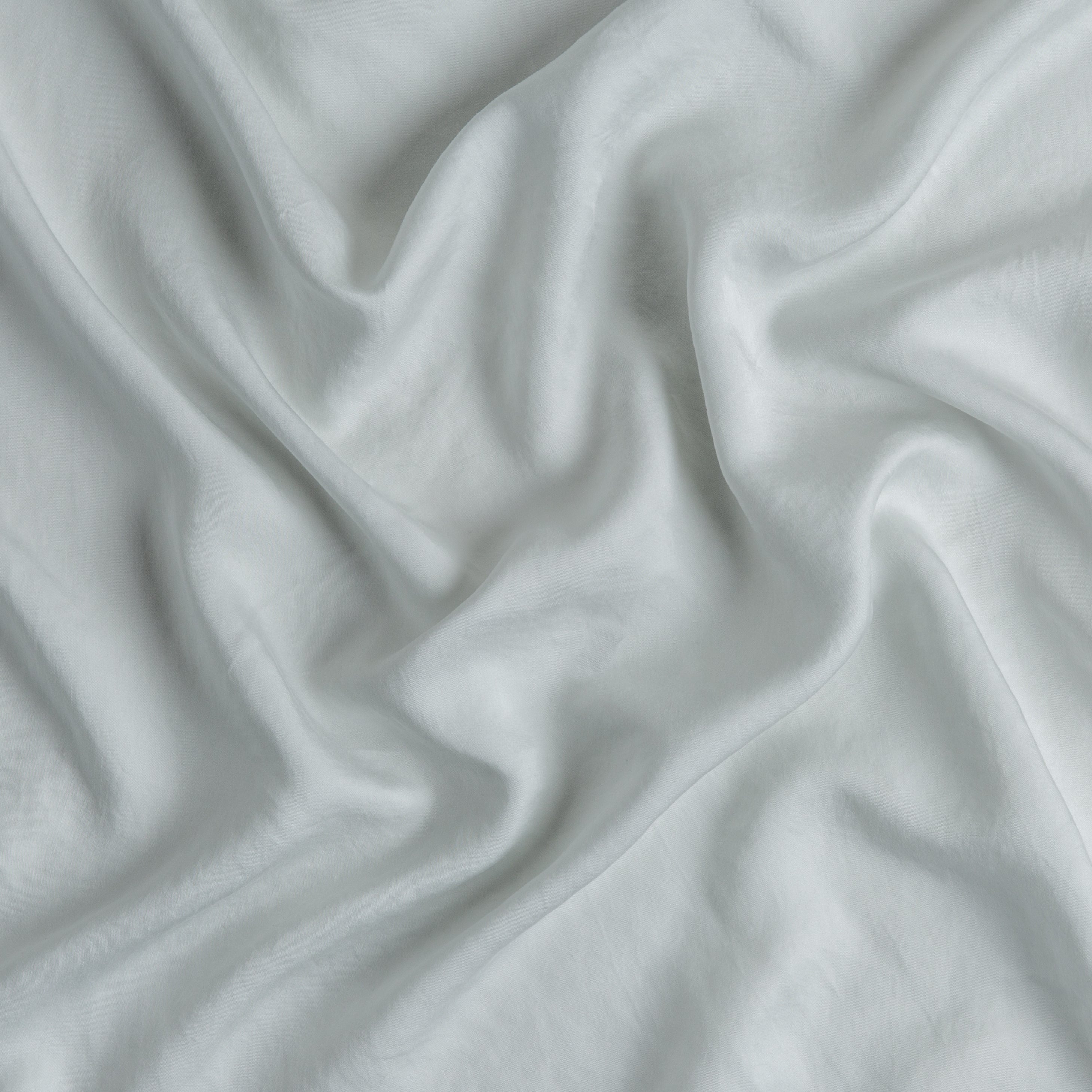 Cloud: A close up of Tencel™ fabric in cloud, a soft, subtle sky blue-grey.