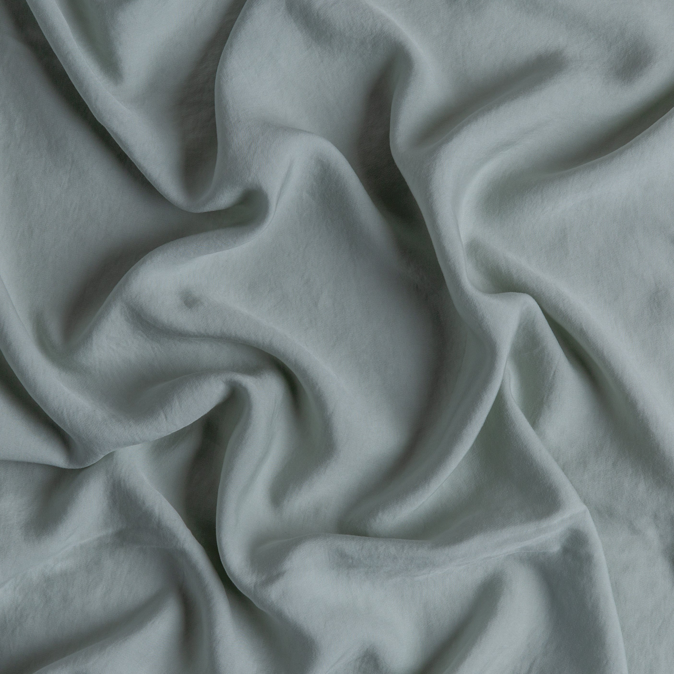 Eucalyptus: A close up of Tencel™ fabric in eucalyptus, a soft light green.