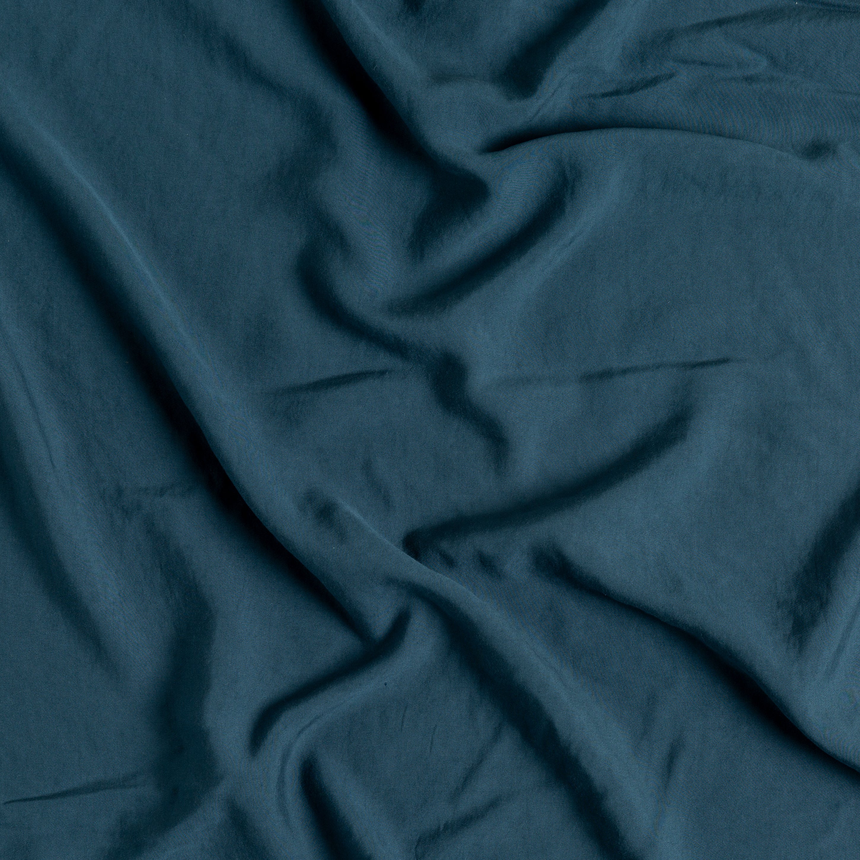 Midnight: A close up of Tencel™ fabric in midnight, a rich indigo tone.