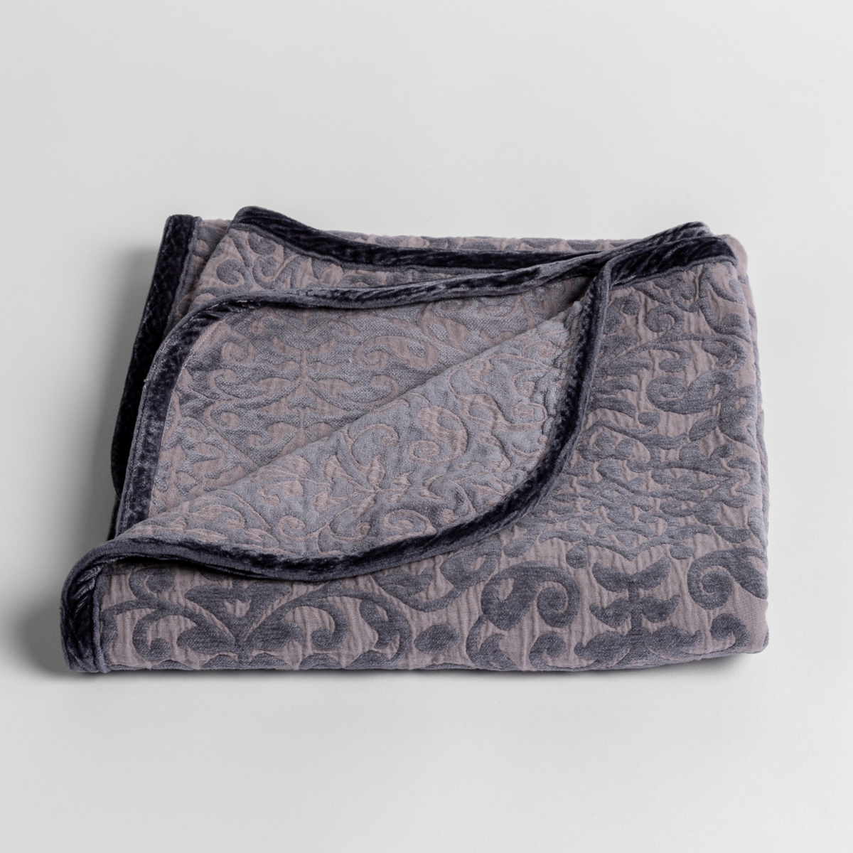 French Lavender: cotton chenille blanket folded with a corner folded back showing the silk velvet trim.