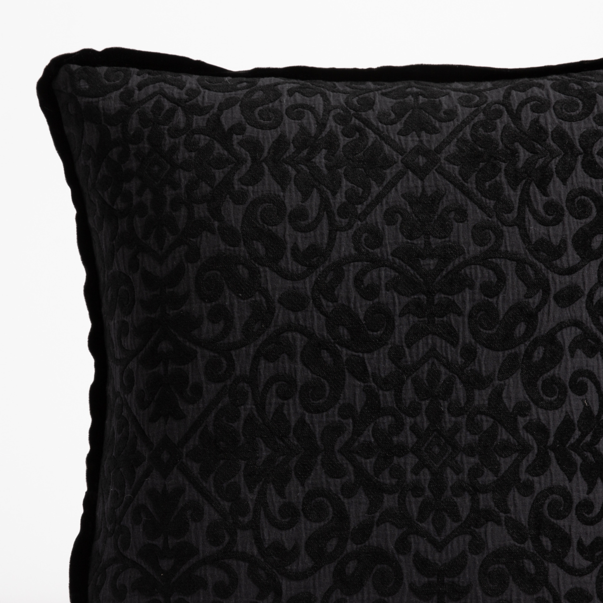Corvino: close up of vienna pillow in corvino corner detail showing pattern and silk vlevet trim.