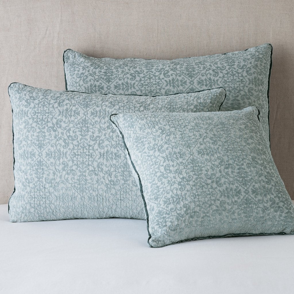 Eucalyptus: Cotton chenille jacquard shams leaning upright against a neutral headboard.