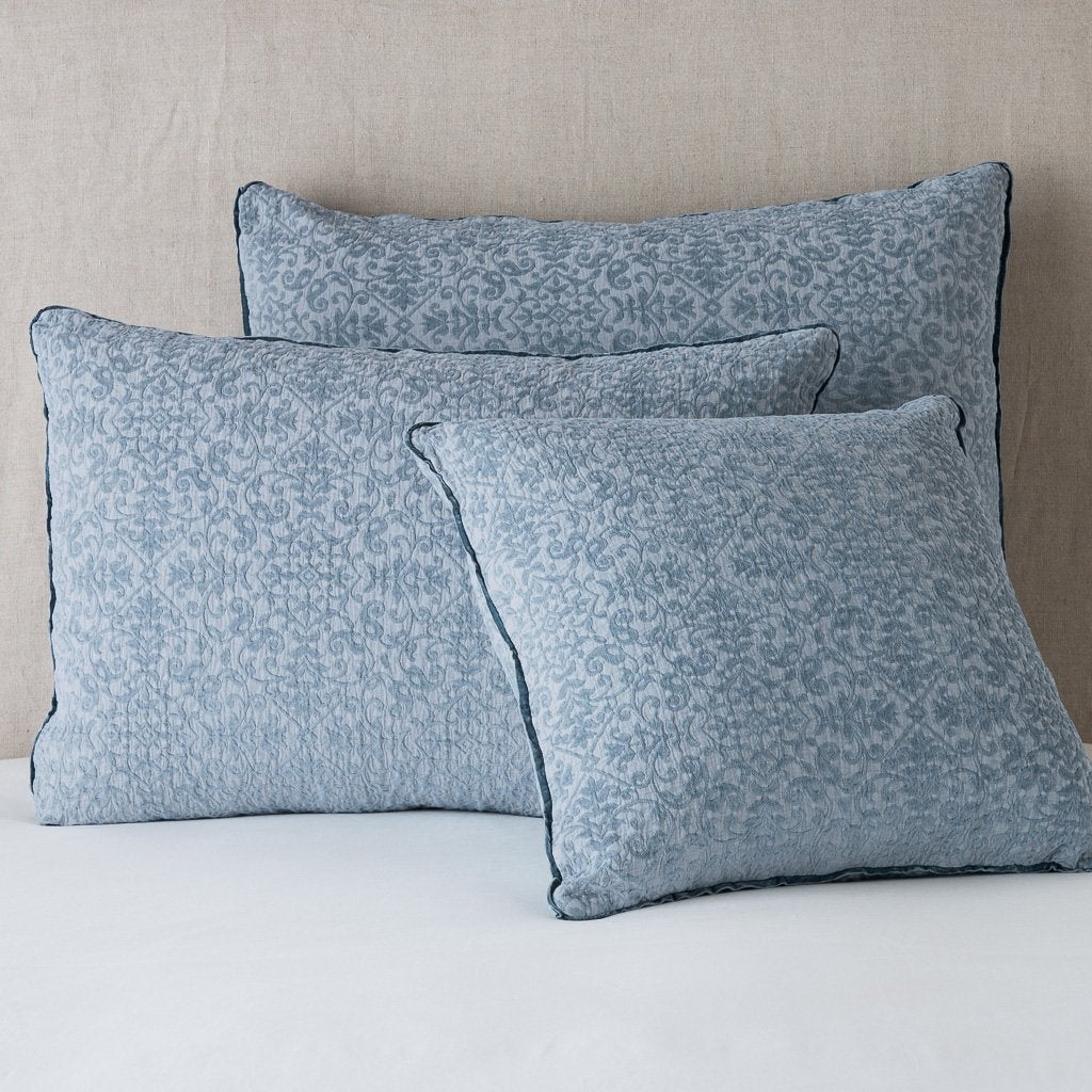 : Vienna shams leaning upright against a neutral headboard - mineral.